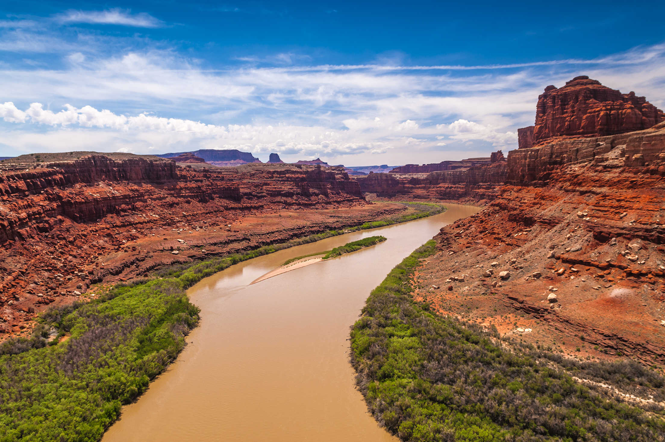 The murky Colorado River flows past Dead Horse State Park’s West Rim overlook trail.