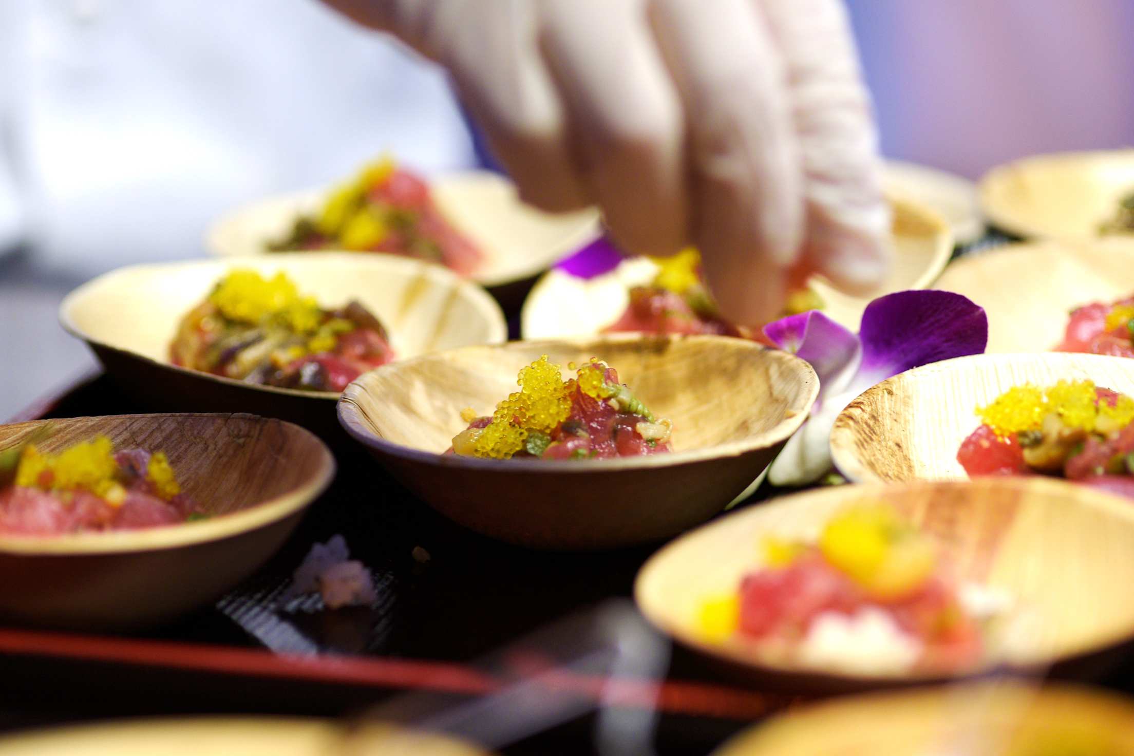 A chef places finishing touches on the big eye tuna poke at Raku in Las Vegas.