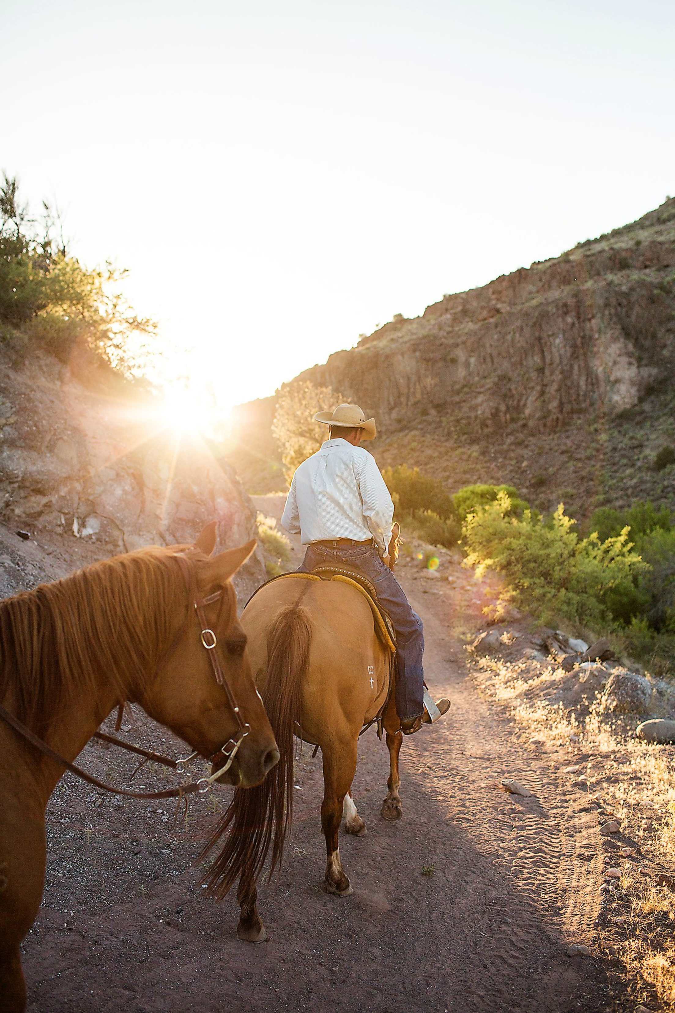 A Horsin' Around Adventures' guide leads horseback riders on a tour near Sedona, Arizona.