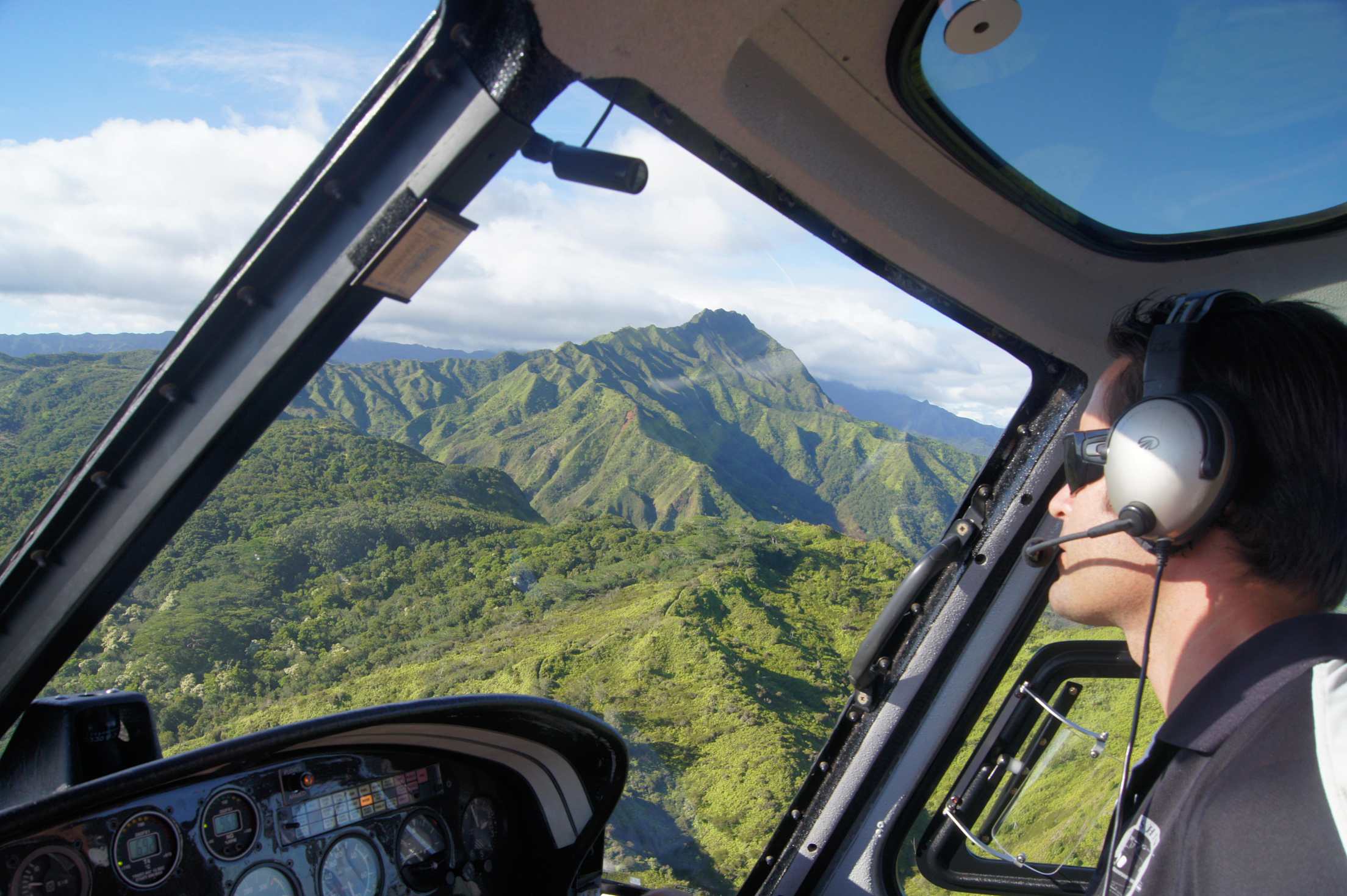 A pilot takes tourists on a helicopter tour over Kaua‘i, Hawaii.