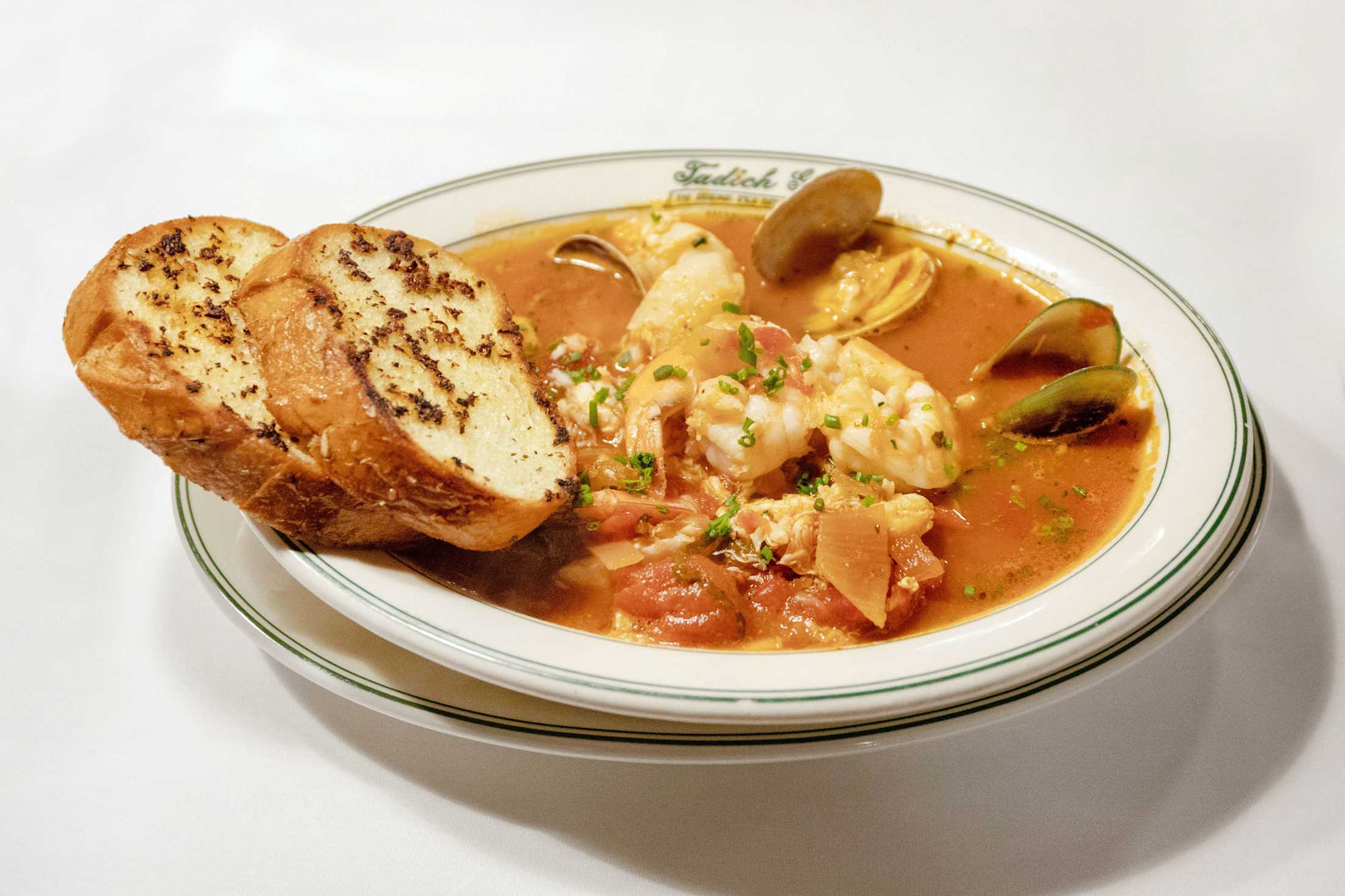 Cioppino in a white bowl at Tadich Grill in San Francisco, California.