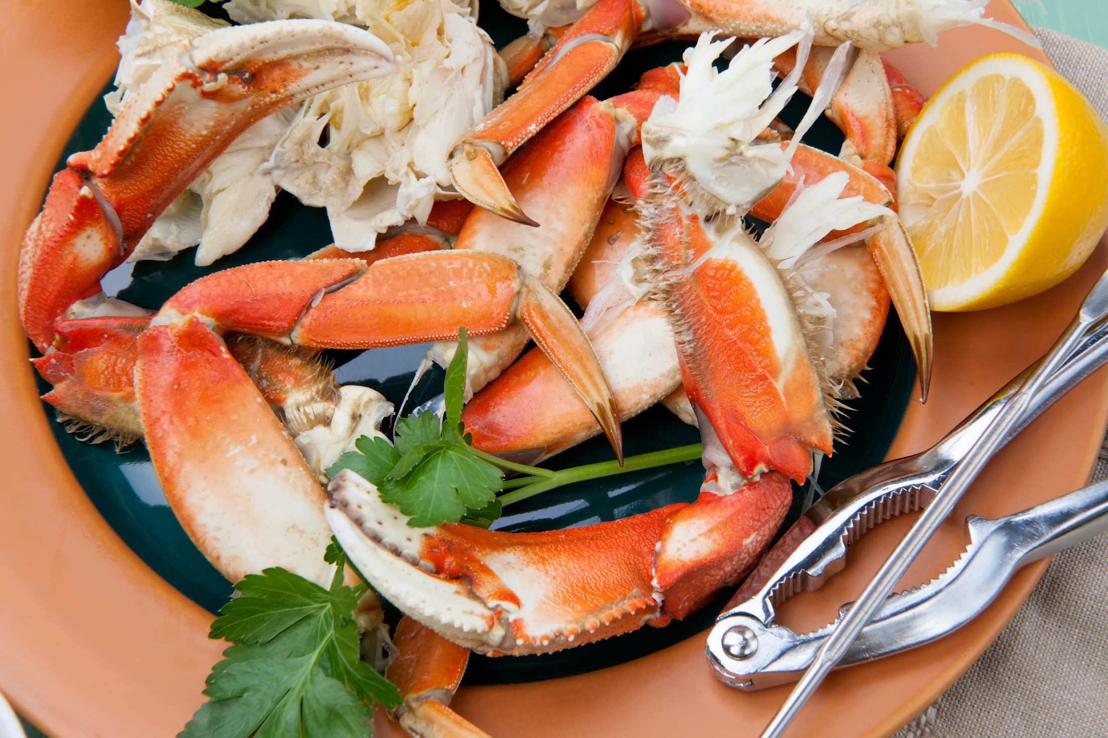 Assorted Dungeness crab legs with butter mustard sauce and fresh lemons