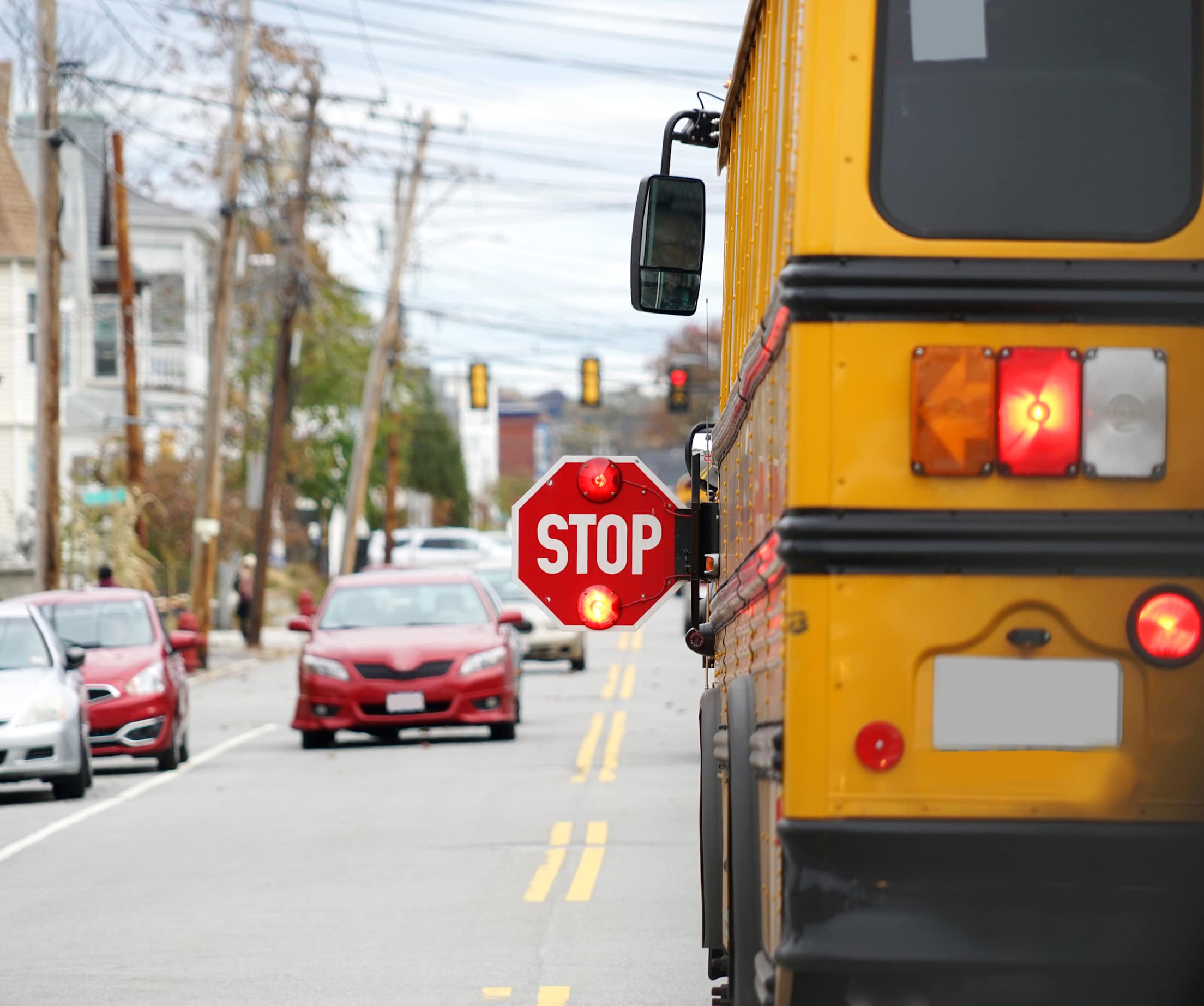 A school bus with its stop sign extended.