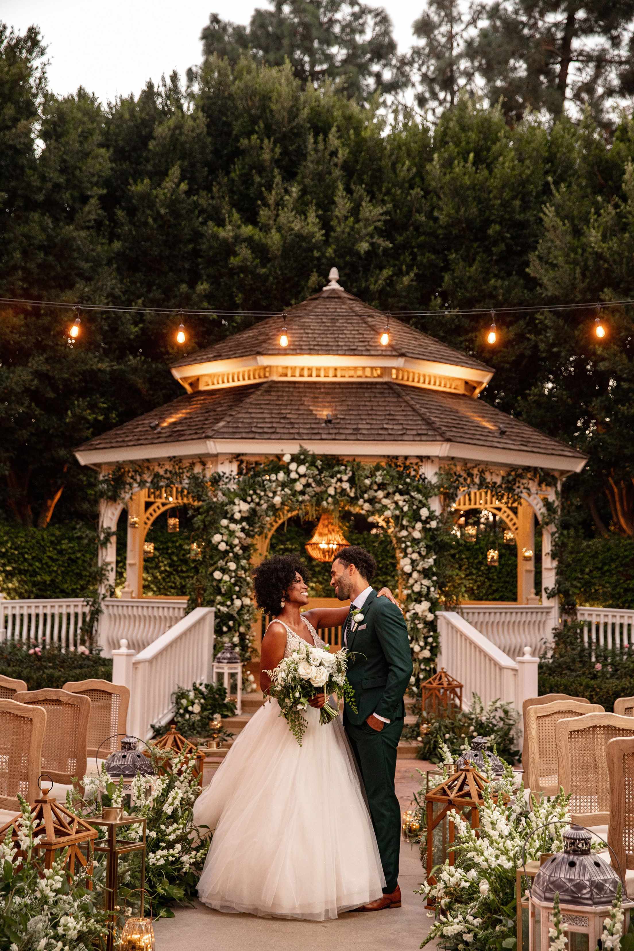 A couple stand in front of a wedding gazebo at Disneyland Resort.