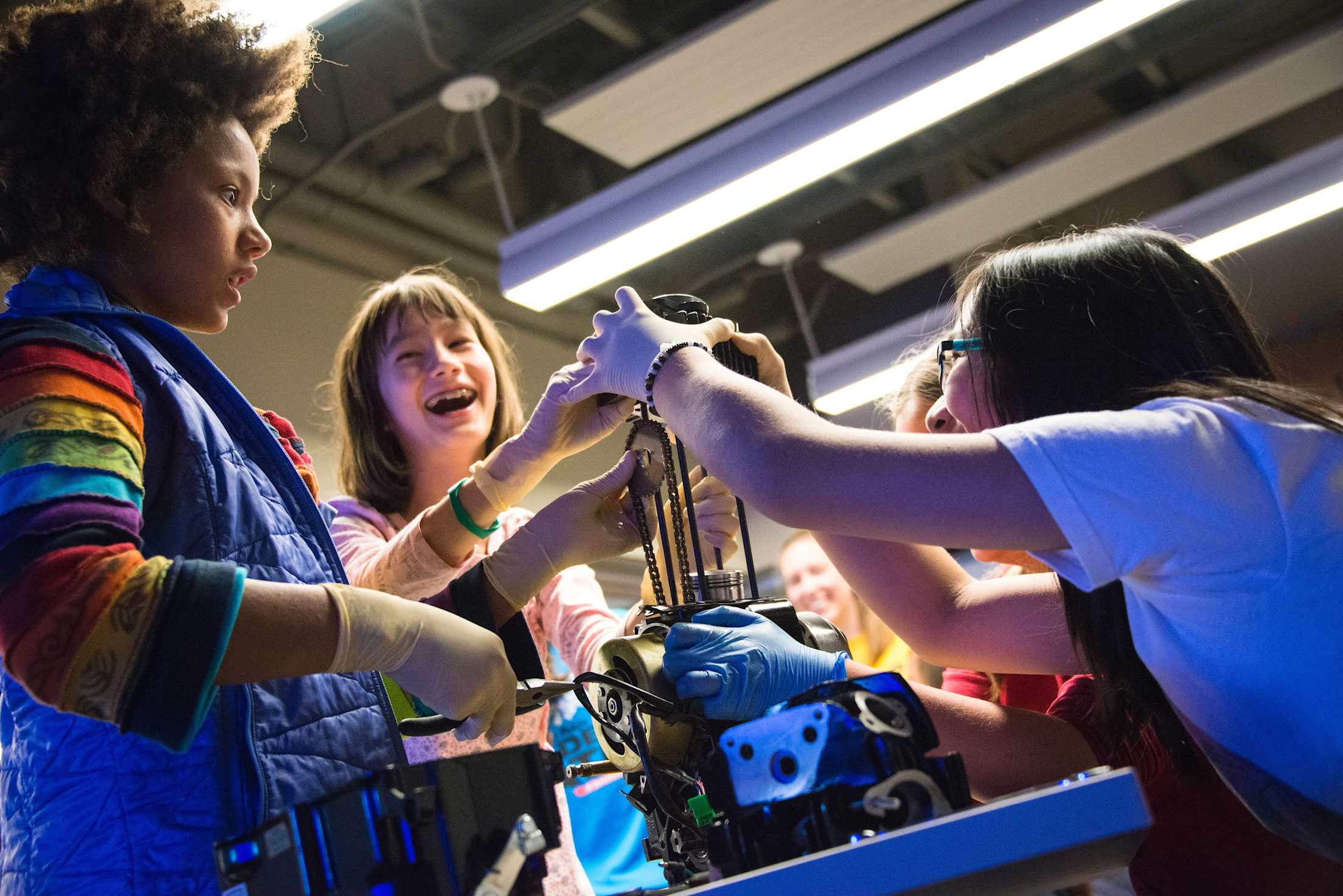Children interact with a science exhibit.