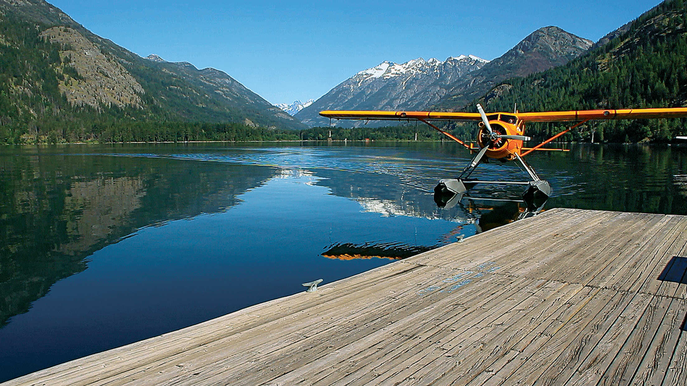 a yellow seaplane on the water of Lake Chelan, Washington