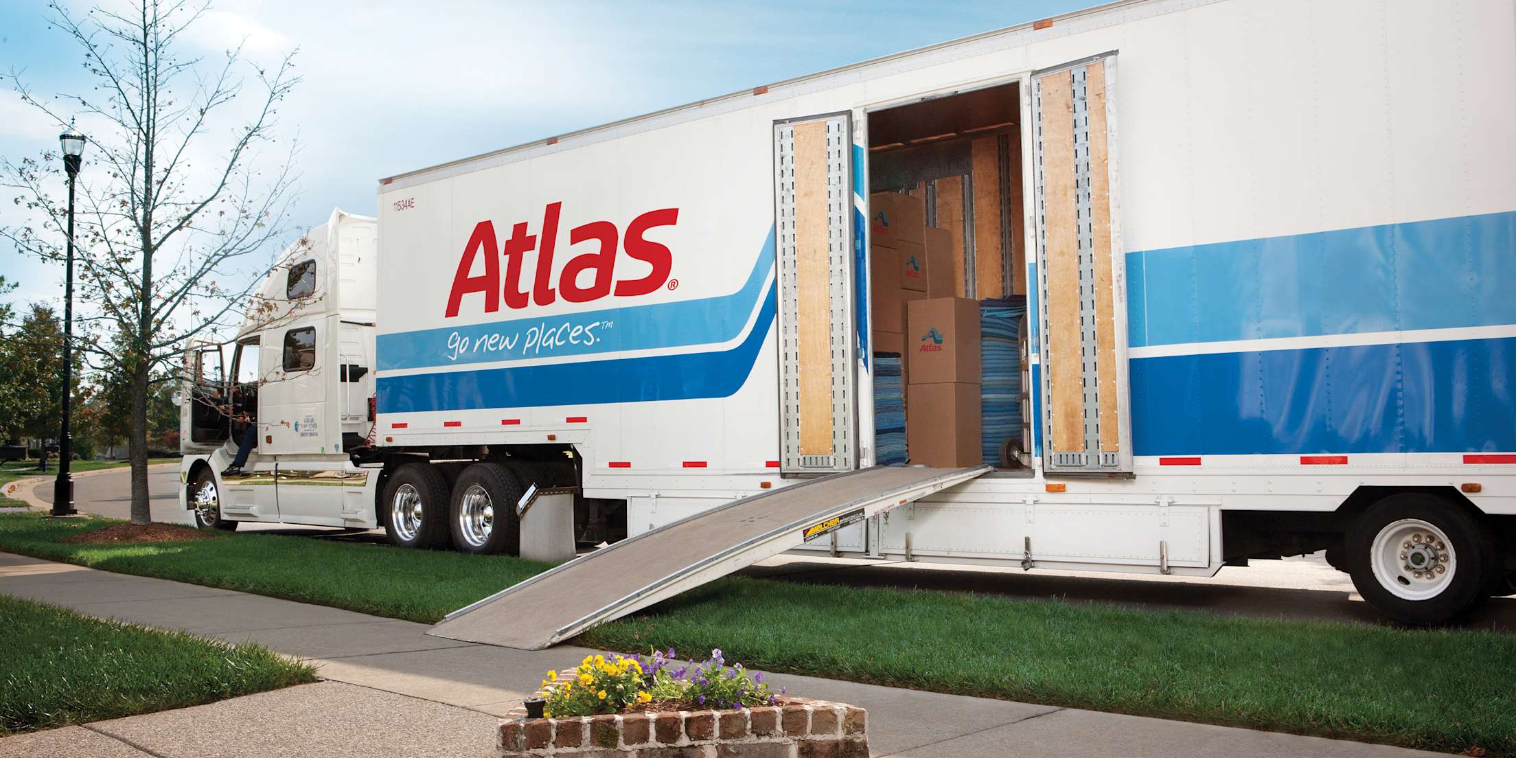 A moving truck parked at a curb.