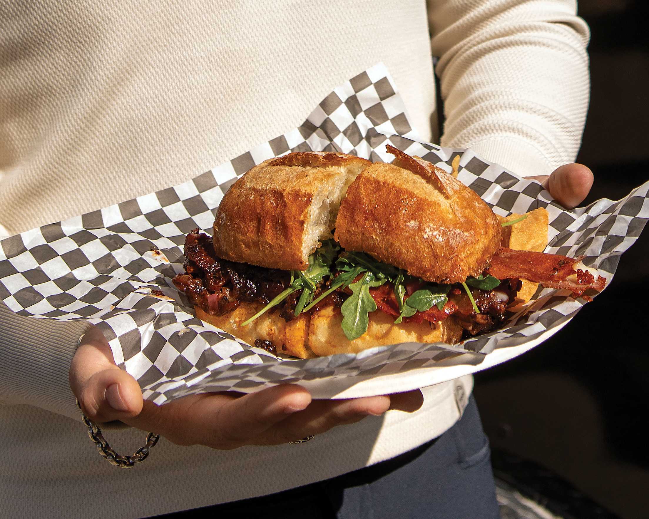 a barbecue sandwich presented on a paper plate