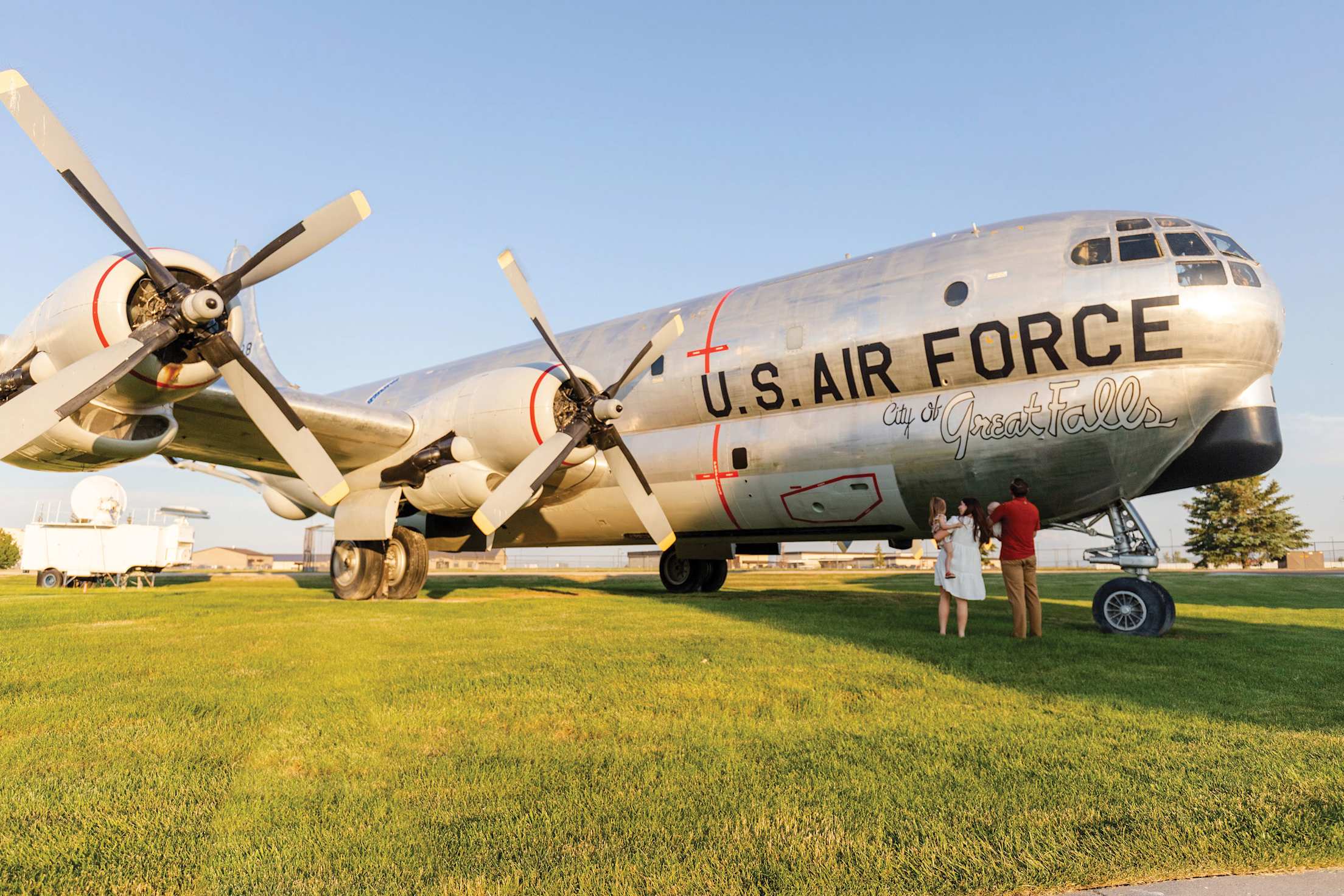 a vintage US air force plane parked on a green lawn at a museum