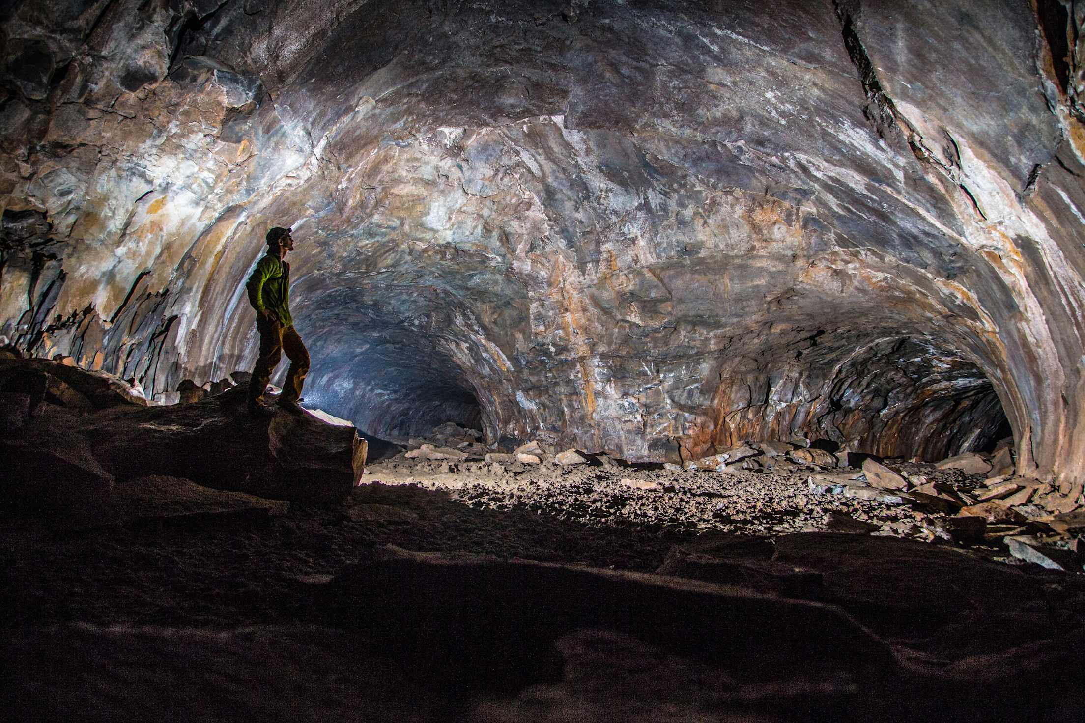 a person exploring a dramatically lit cave