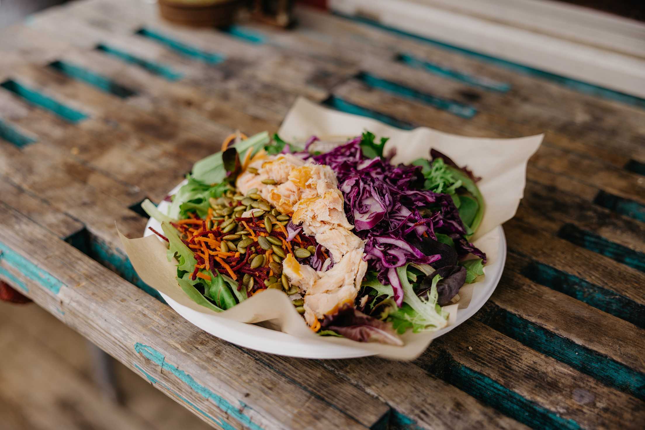 a salmon salad with colorful cabbage