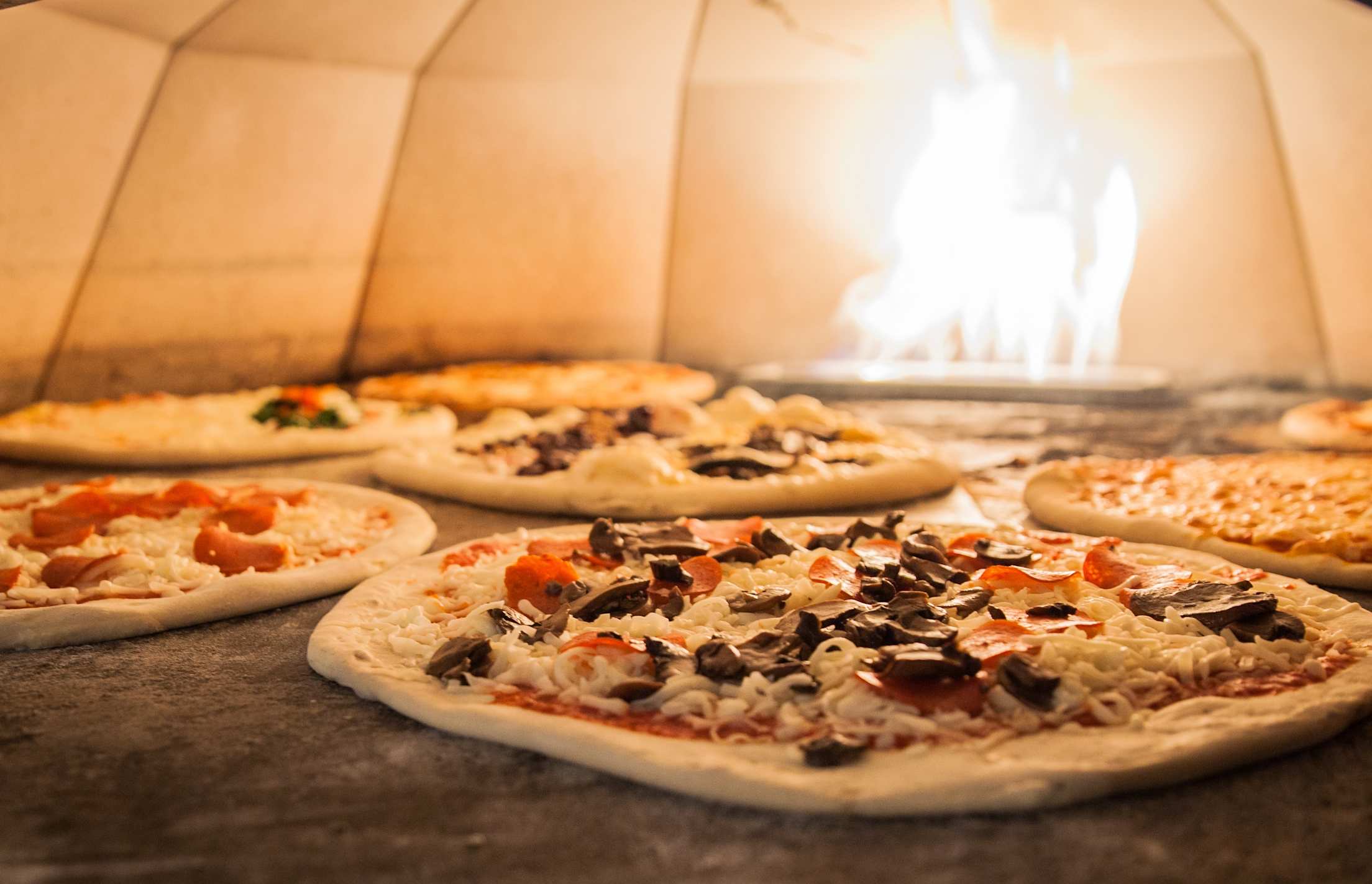 pizzas cooking in an oven