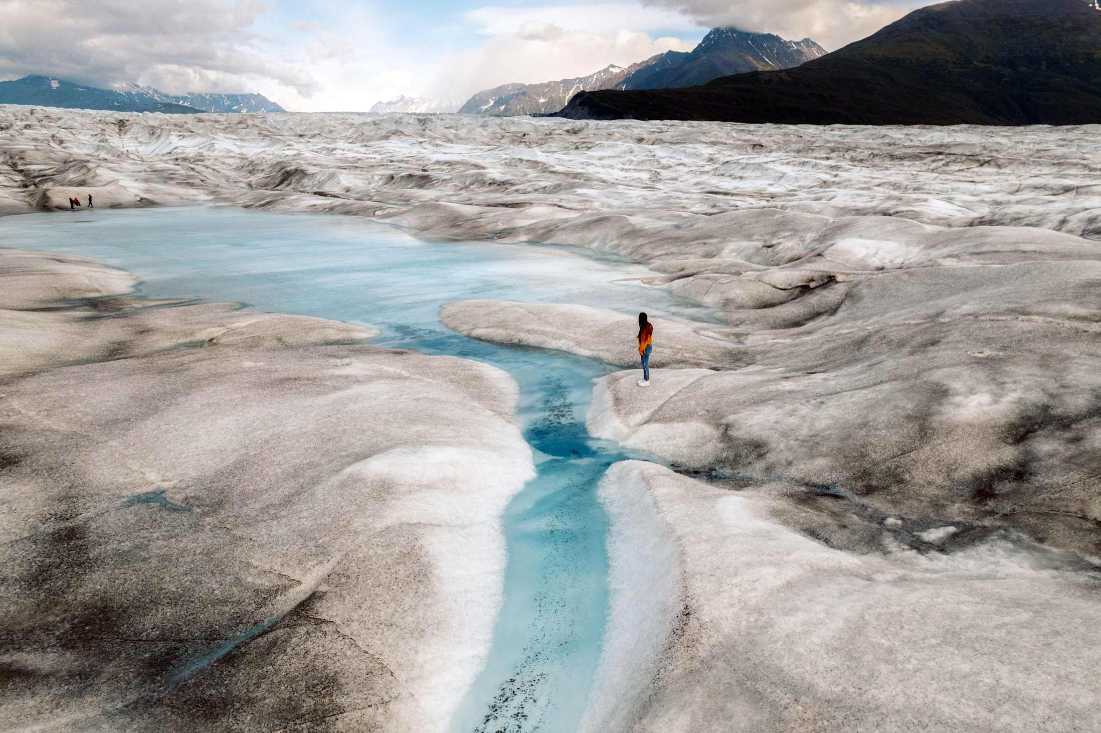 a woman explores a remote glacier