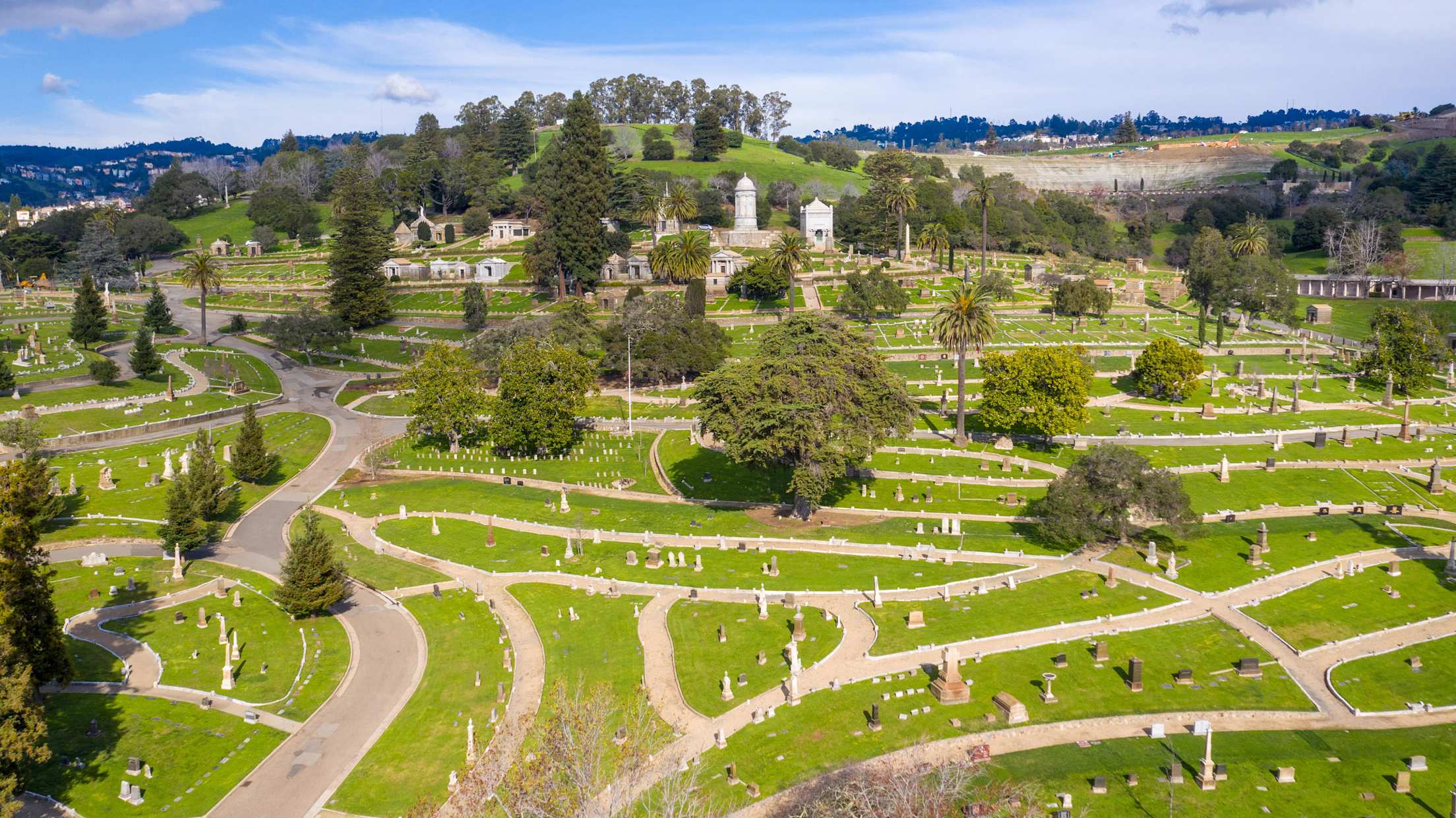 An expansive hilltop cemetery topped with obelisks and trees.
