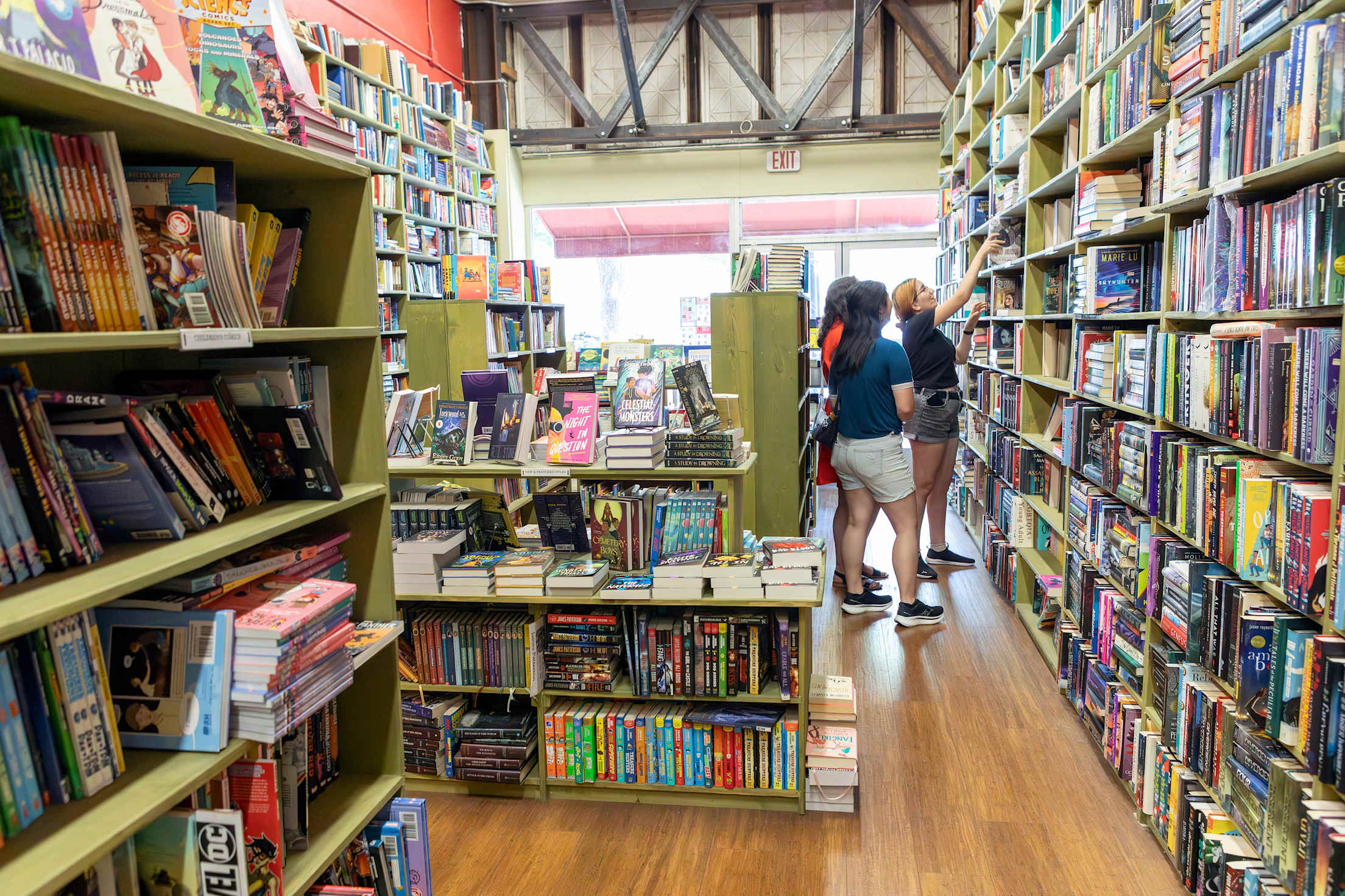 people browse for books inside a packed bookstore
