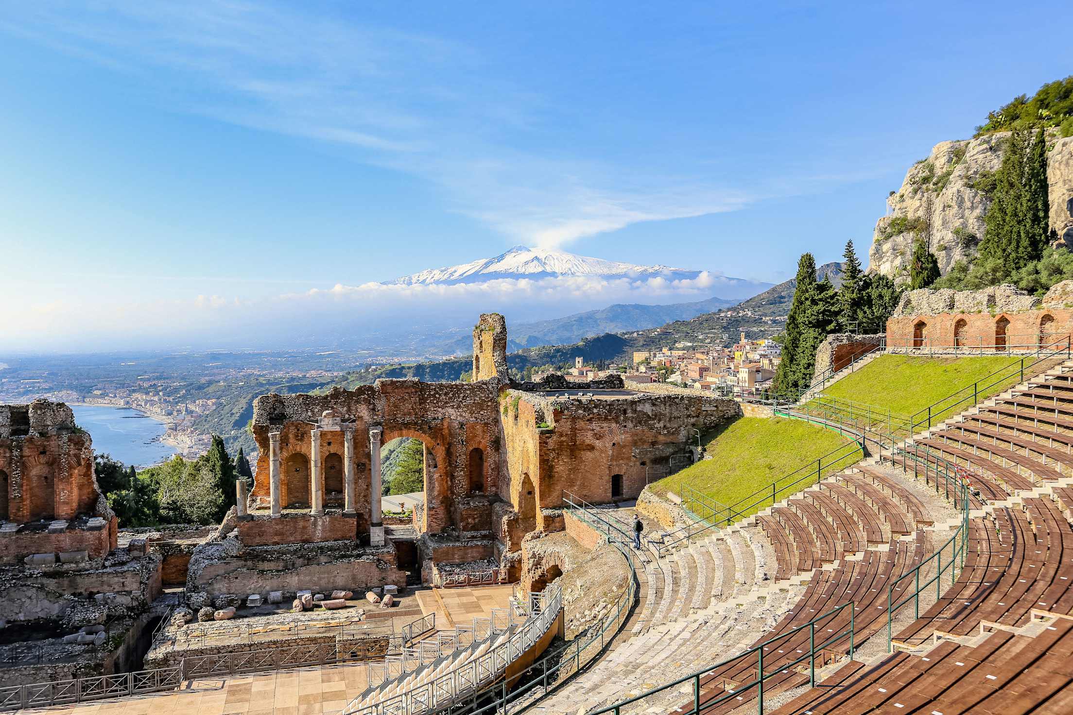 Antique Greek amphitheater, Taormina teatro greco on sunny day in Sicily, Italy.