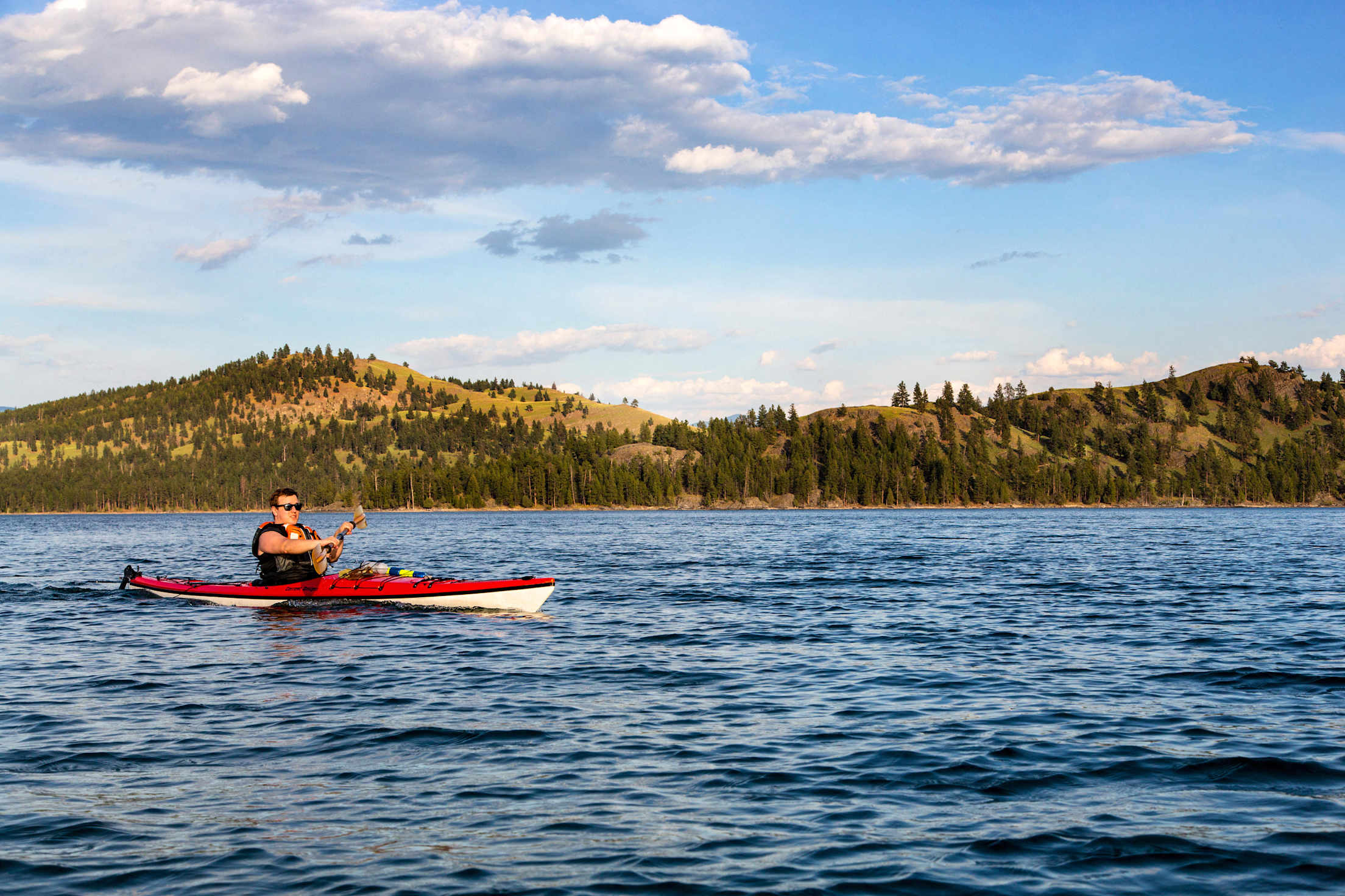 A person kayaks on Flathead Lake in Montana.