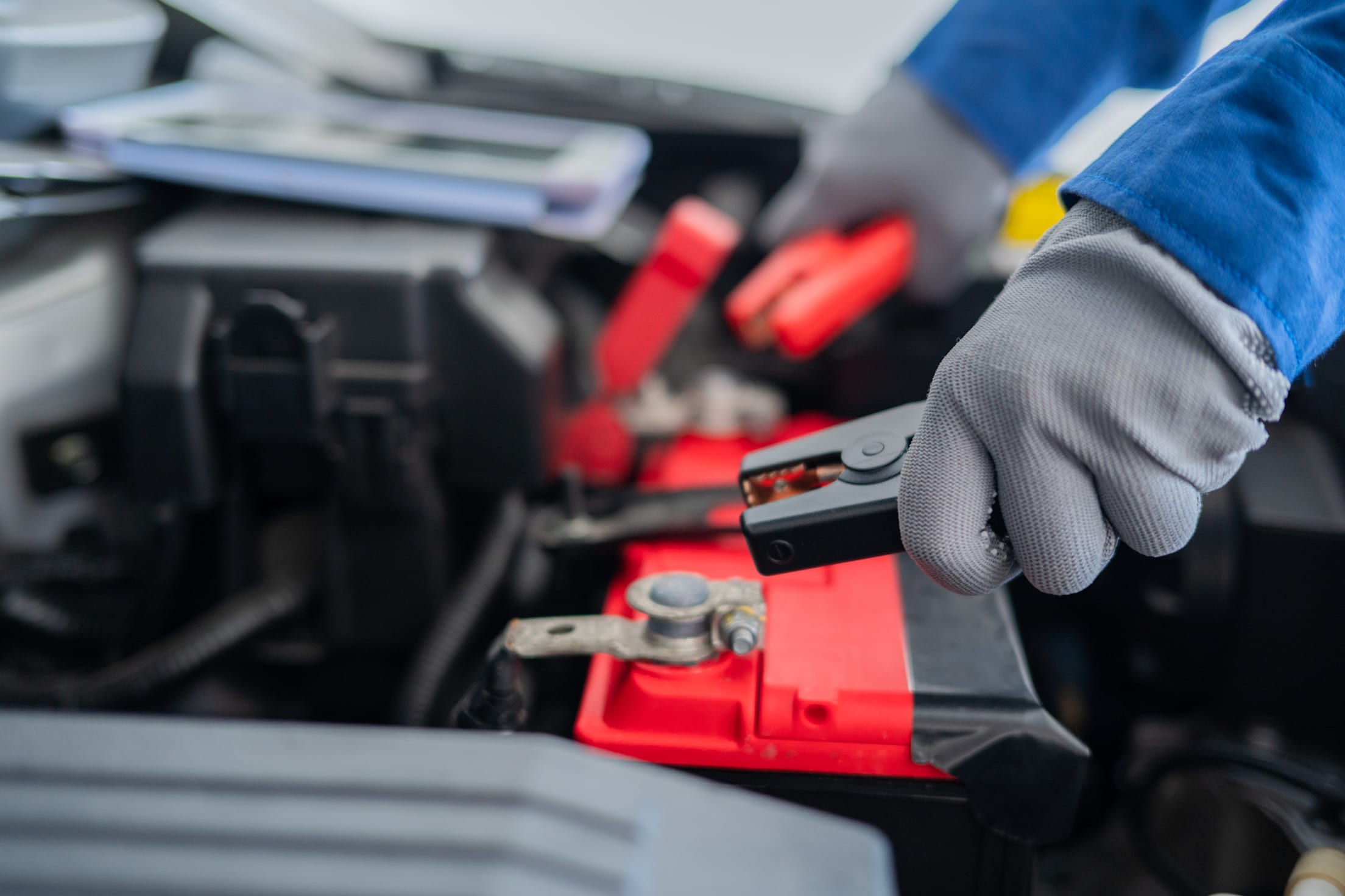 a battery is jump-started with negative and positive cables
