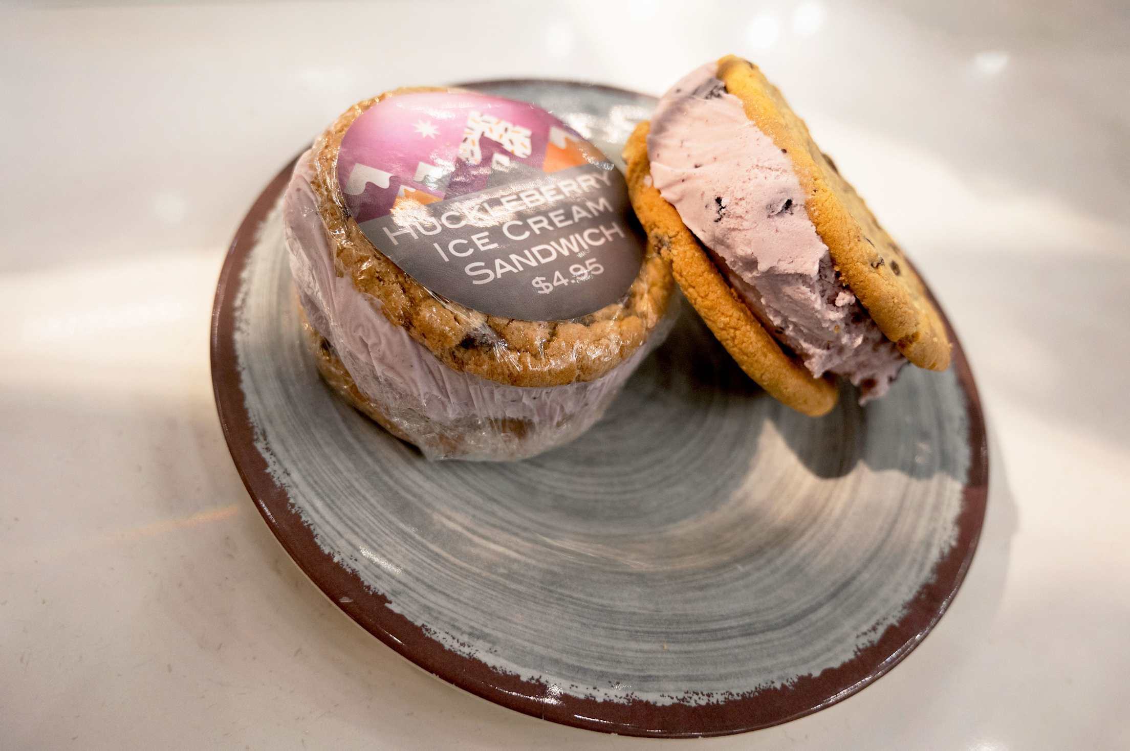two huckleberry ice cream sandwiches wrapped on a plate