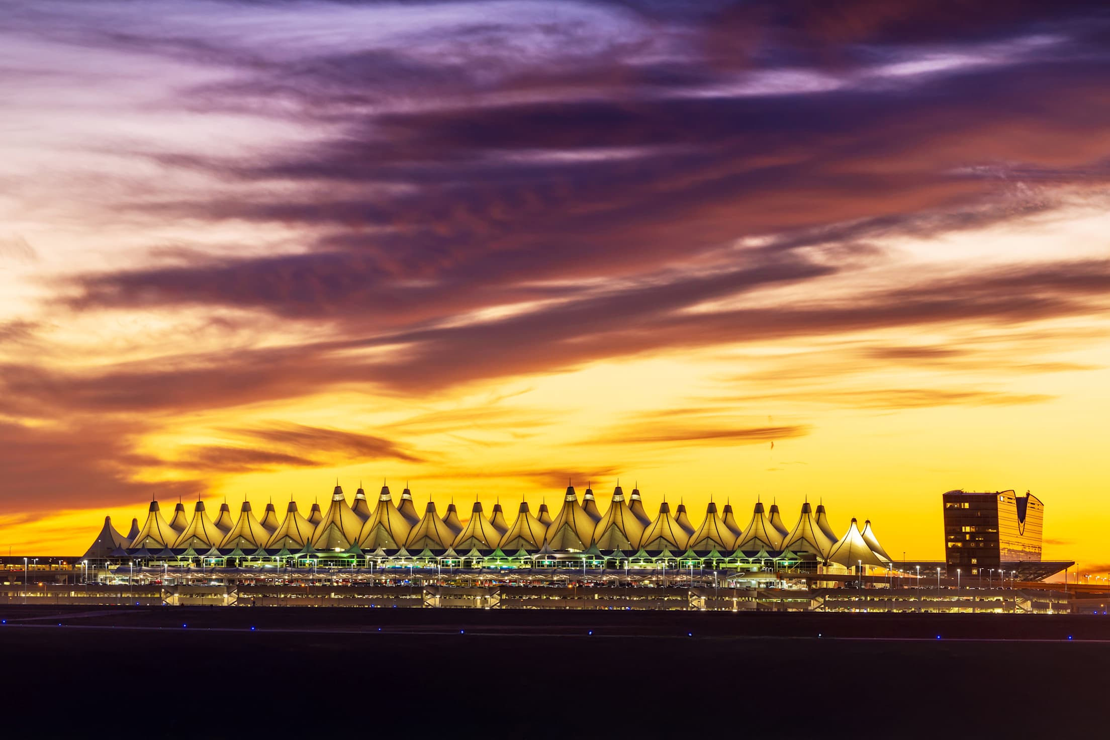 A yellow and purple sunset over the Denver International Airport.
