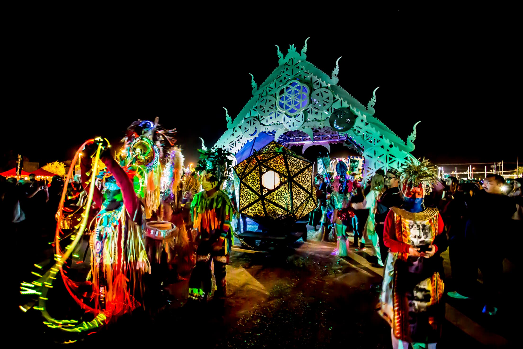 a colorfully lit geometric urn at a day of the dead celebration