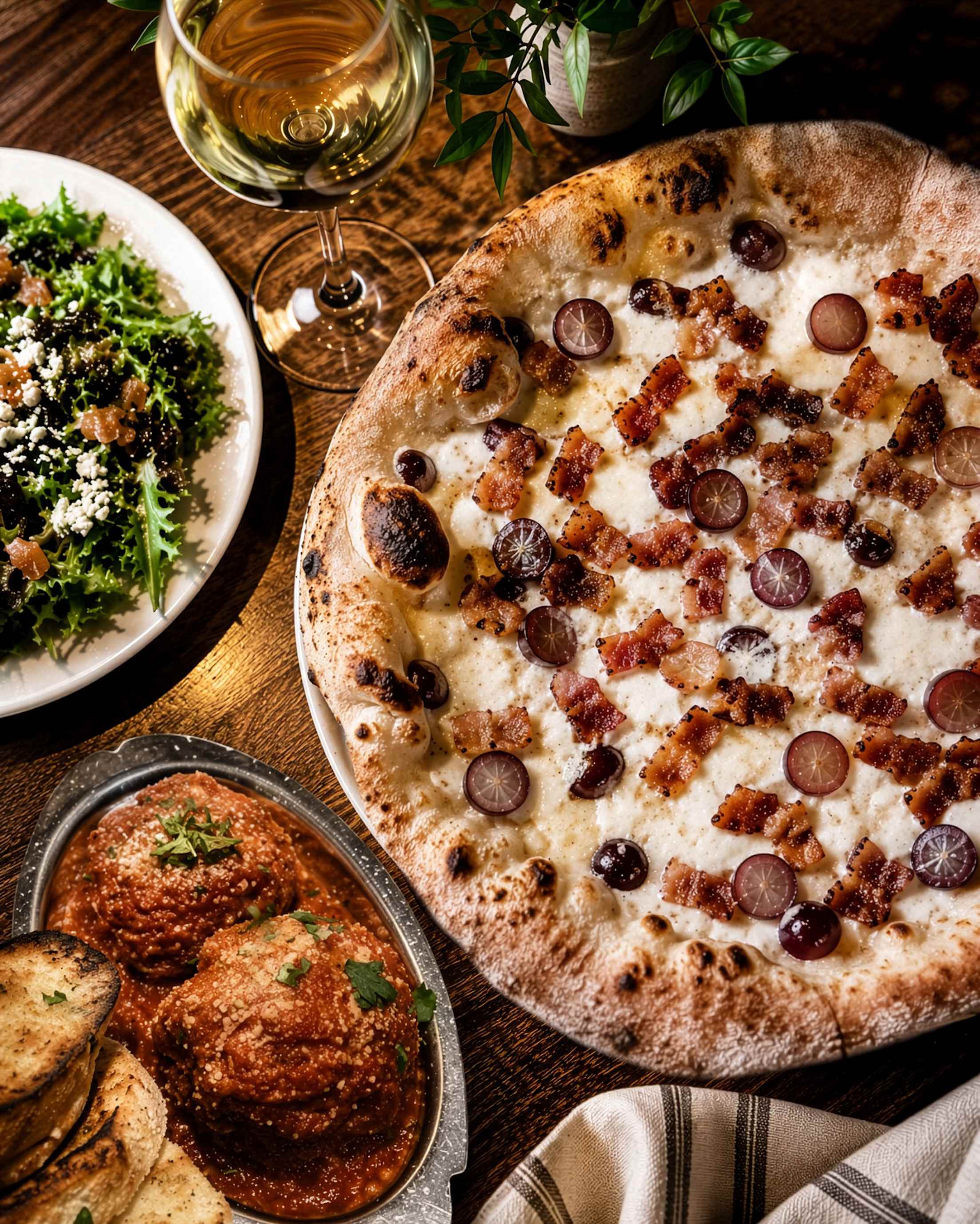 Pancetta and grape pizza on a table at Centro Woodfired Pizzeria.
