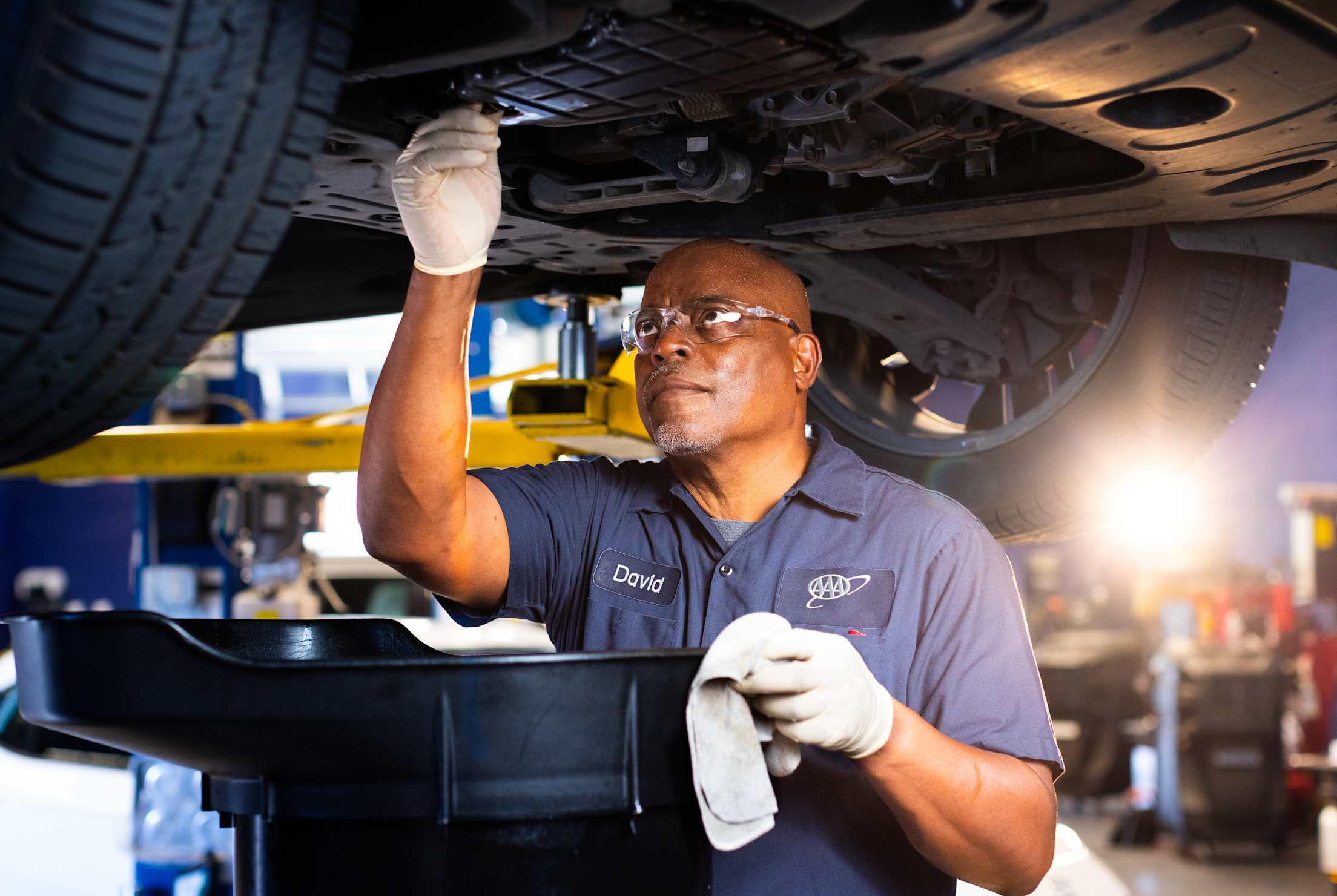 AAA auto repair center ASE-certified technician drains oil