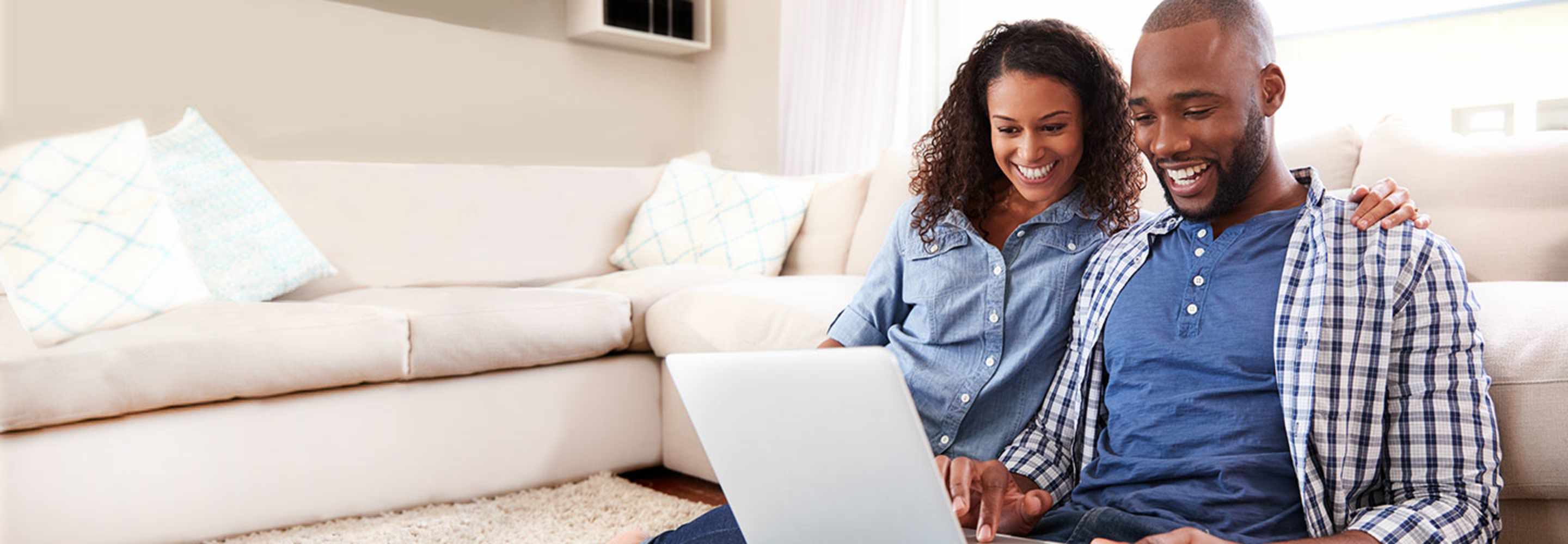 Couple protected by AAA Insurance on their computer reviewing their policy.