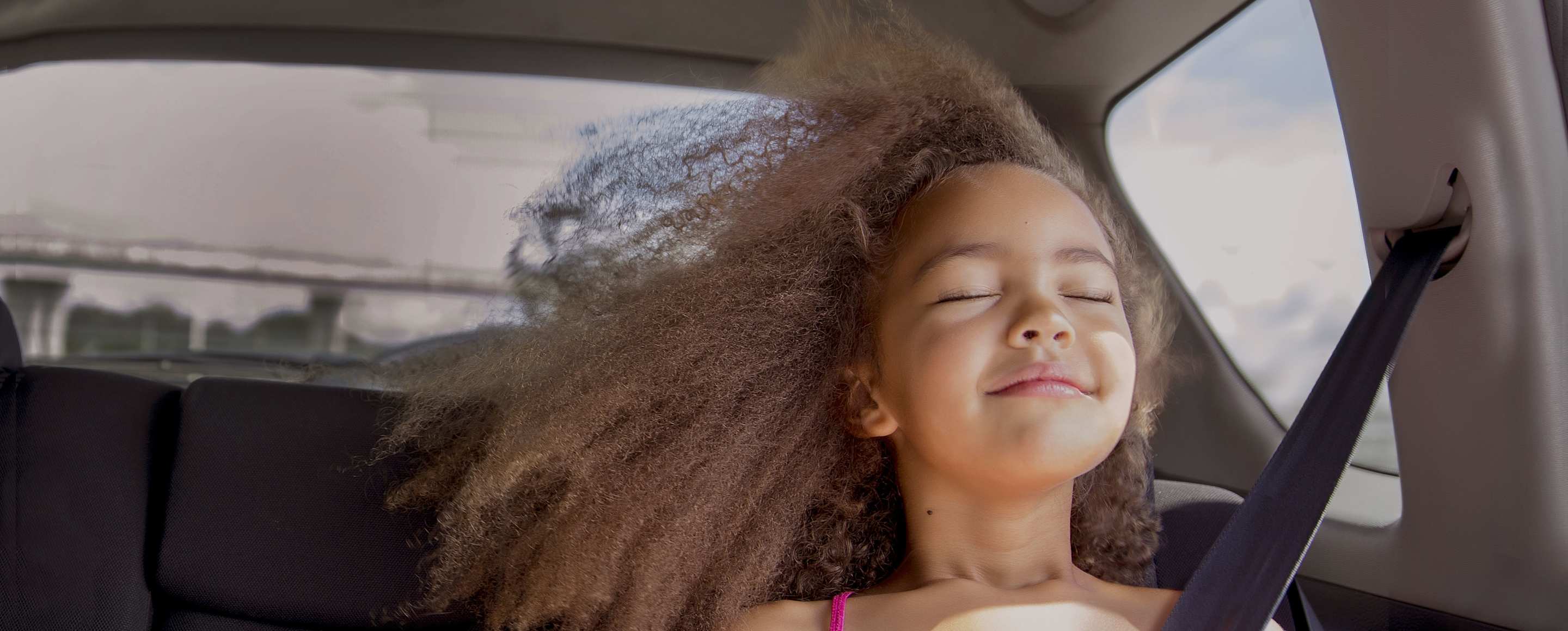 Girl in a car protected by aaa auto insurance