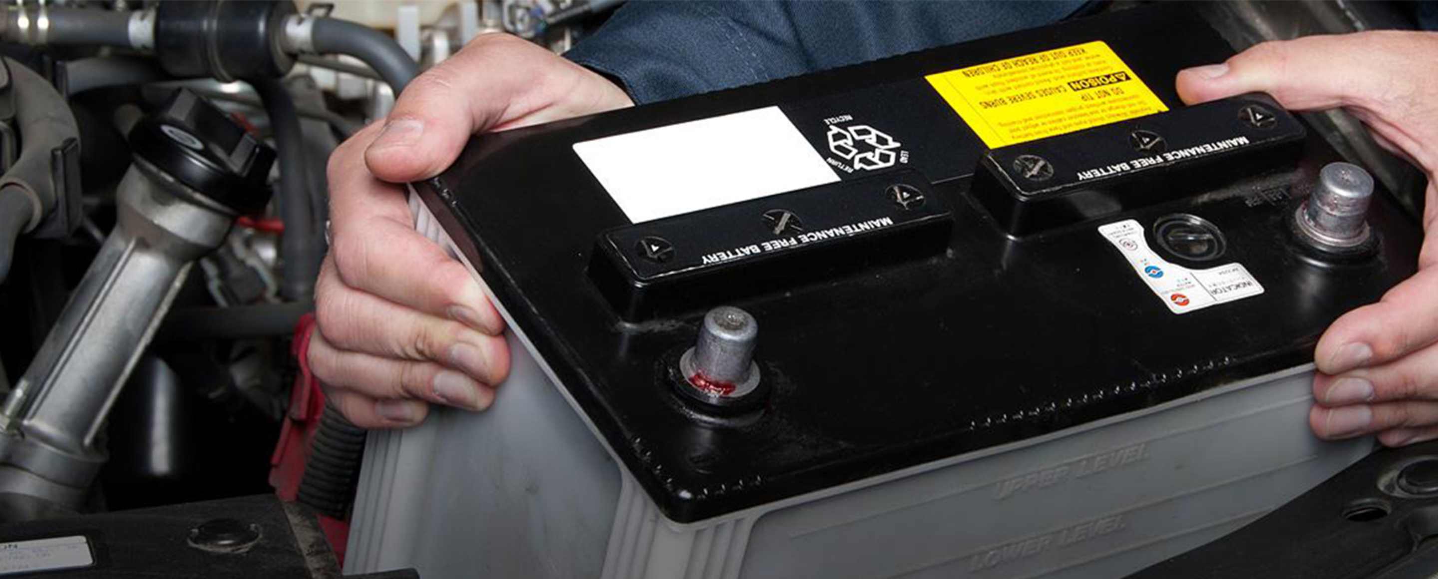 A AAA Roadside Service technician replaces a Member's battery through the AAA Battery Service