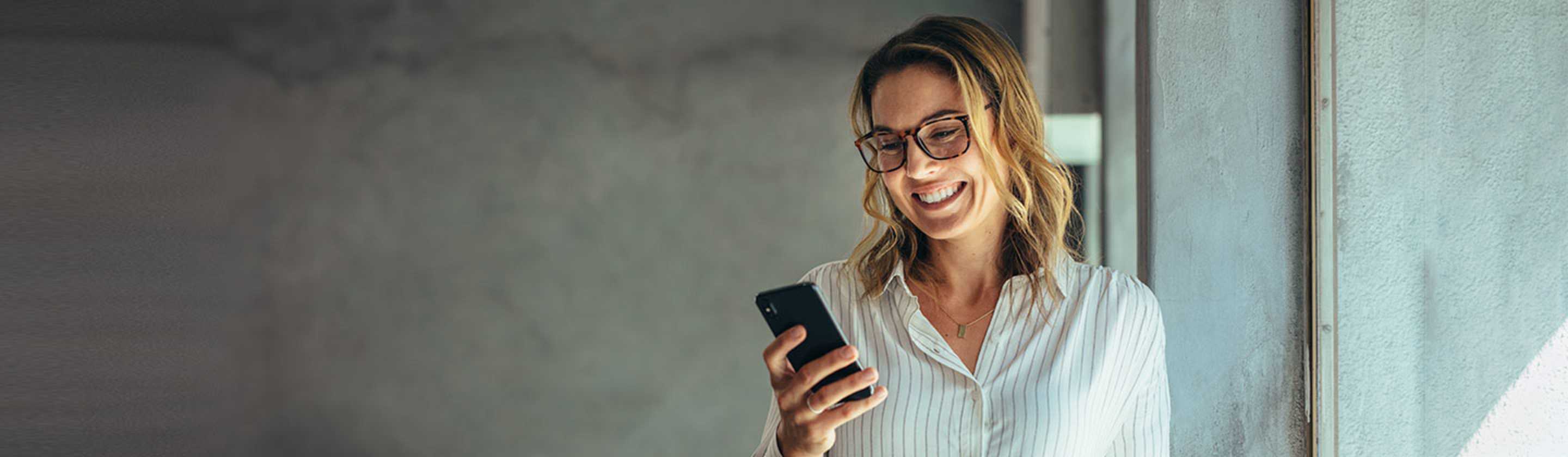 a woman compares AAA Membership costs and benefits on her mobile phone
