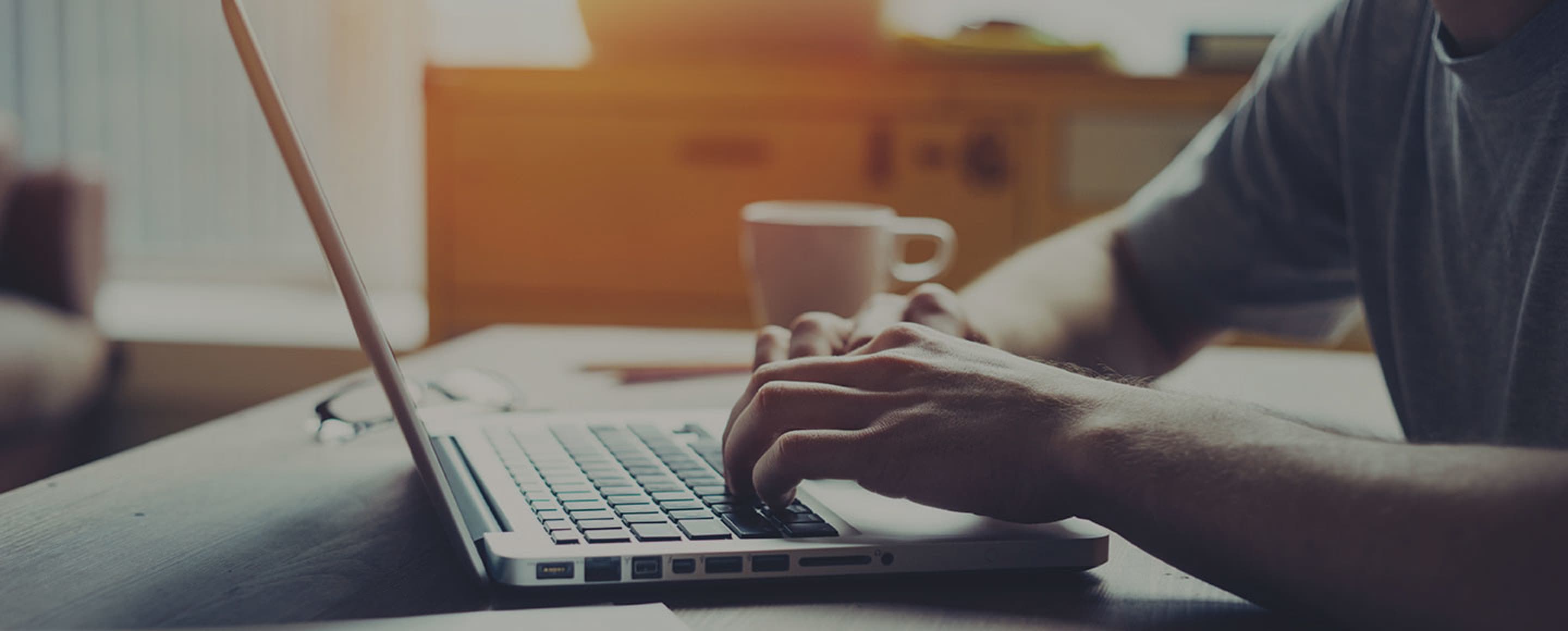 a man completes a AAA reimbursement form on his laptop