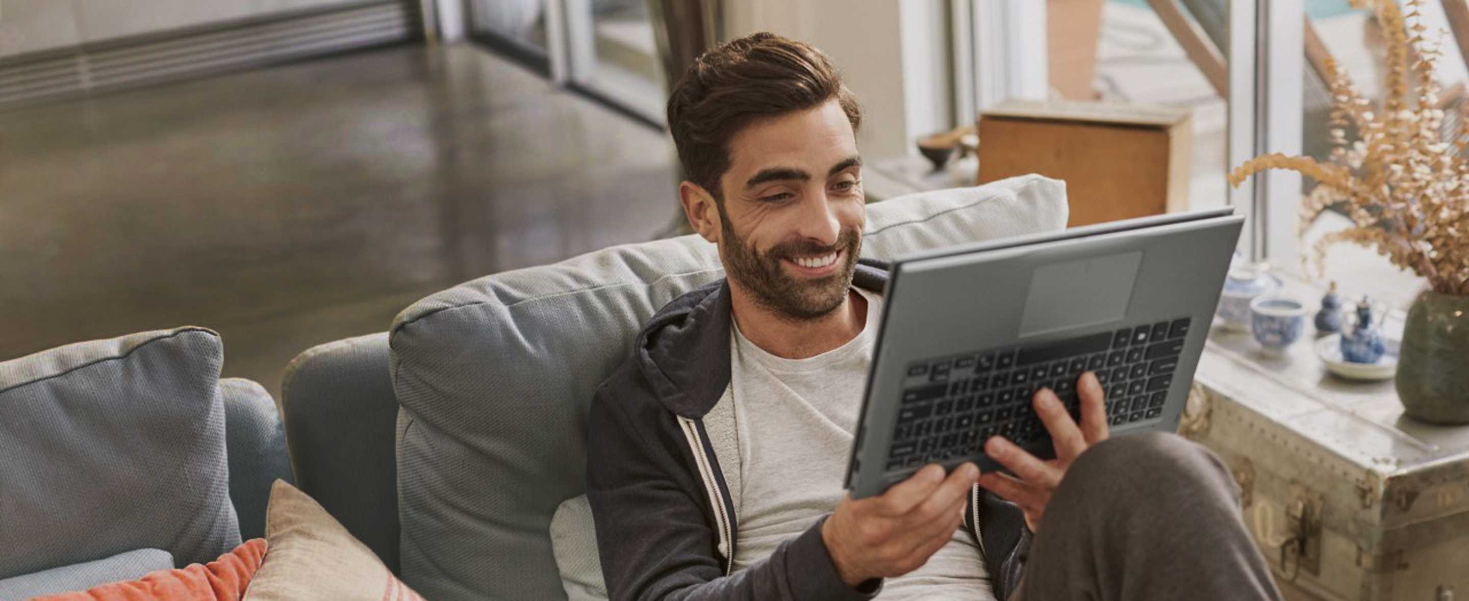 AAA member sitting on his couch using a dell product