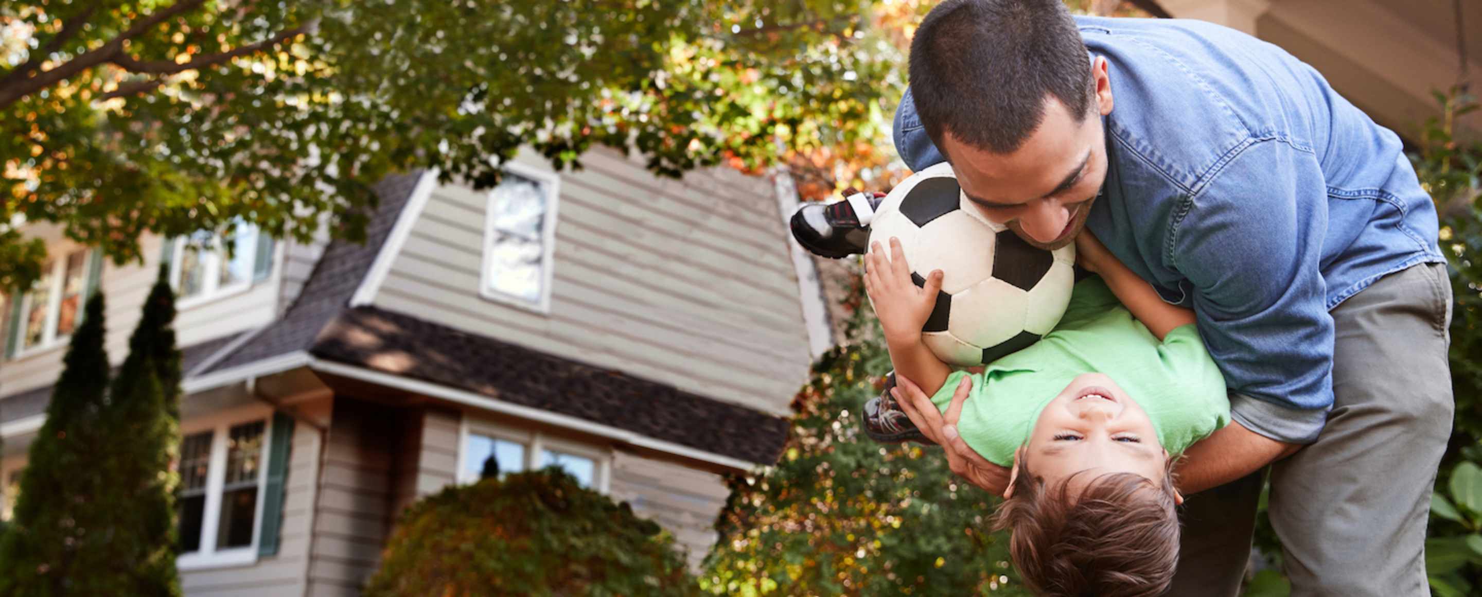 Father protected by AAA life insurance playing with his young son.