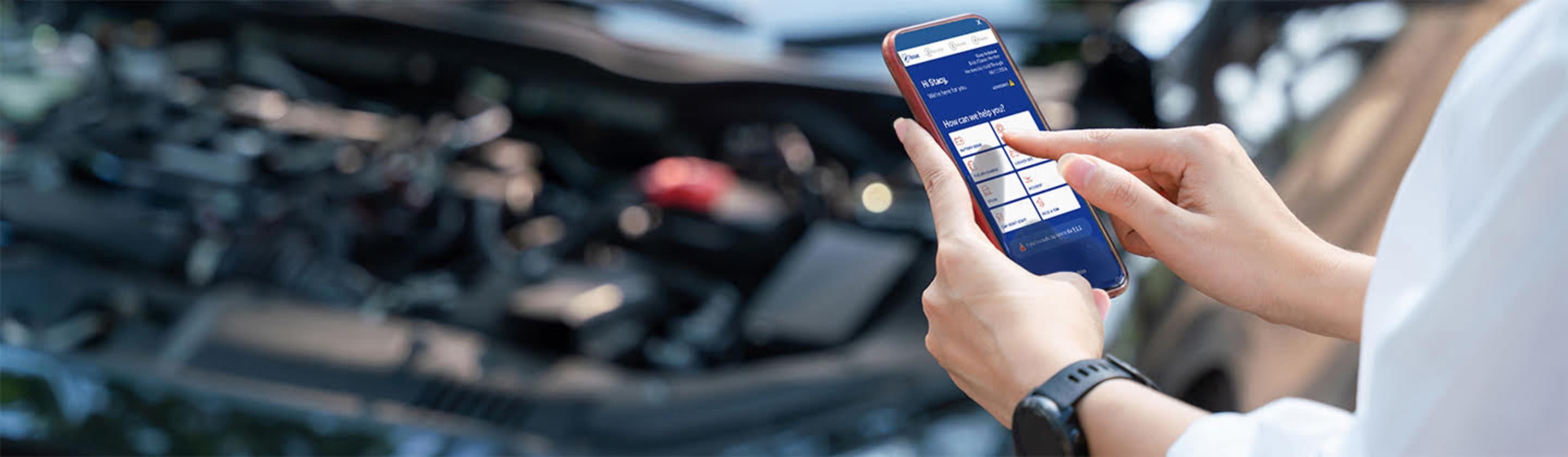 Woman using the AAA app on her mobile phone to request roadside assistance