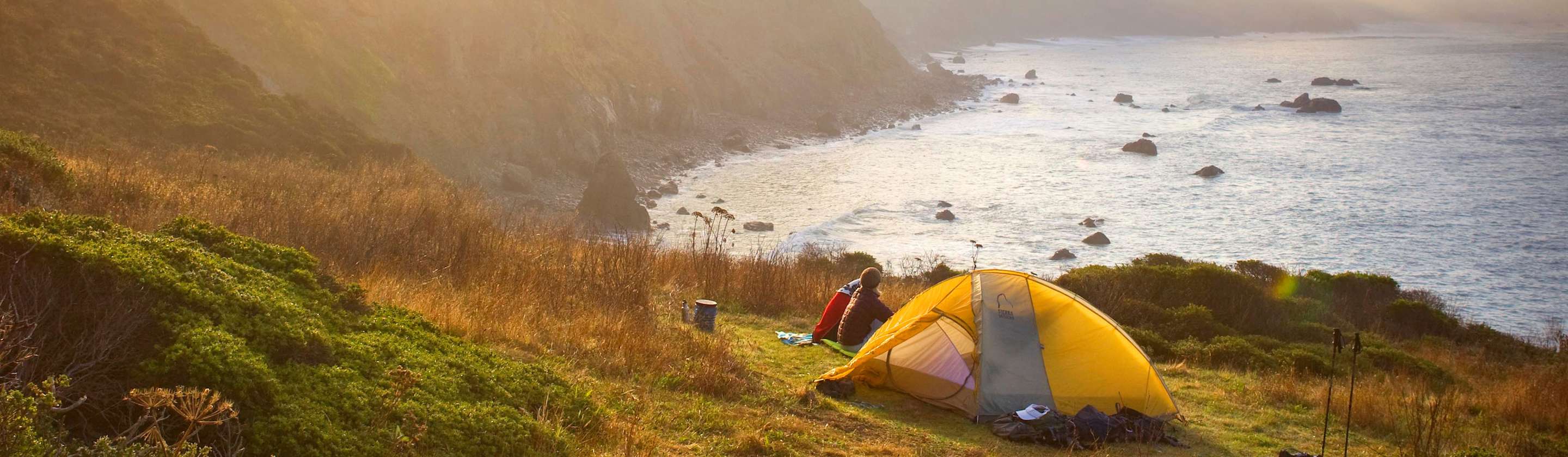 A couple camp on the bluffs above the Pacific Ocean.