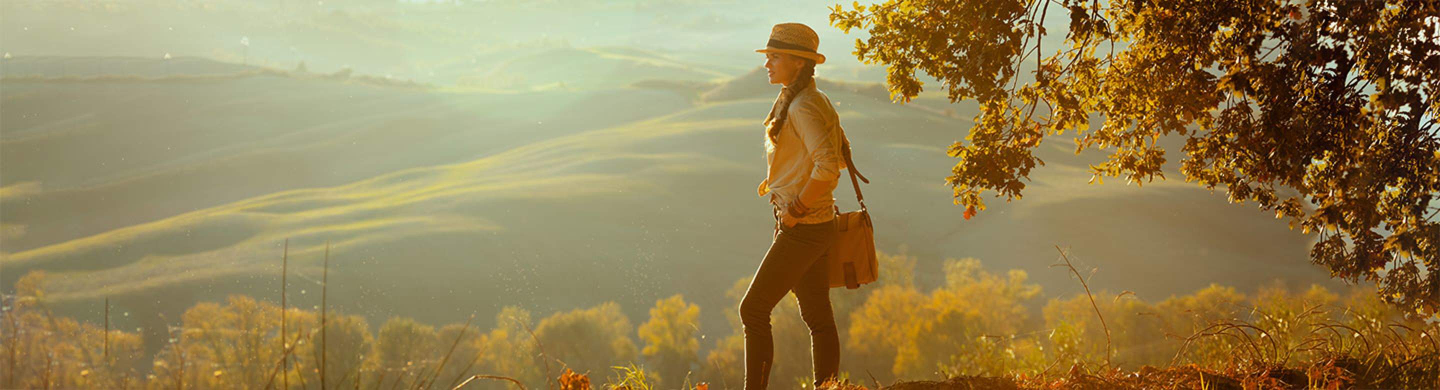 a AAA member on vacation walks through the tuscan countryside
