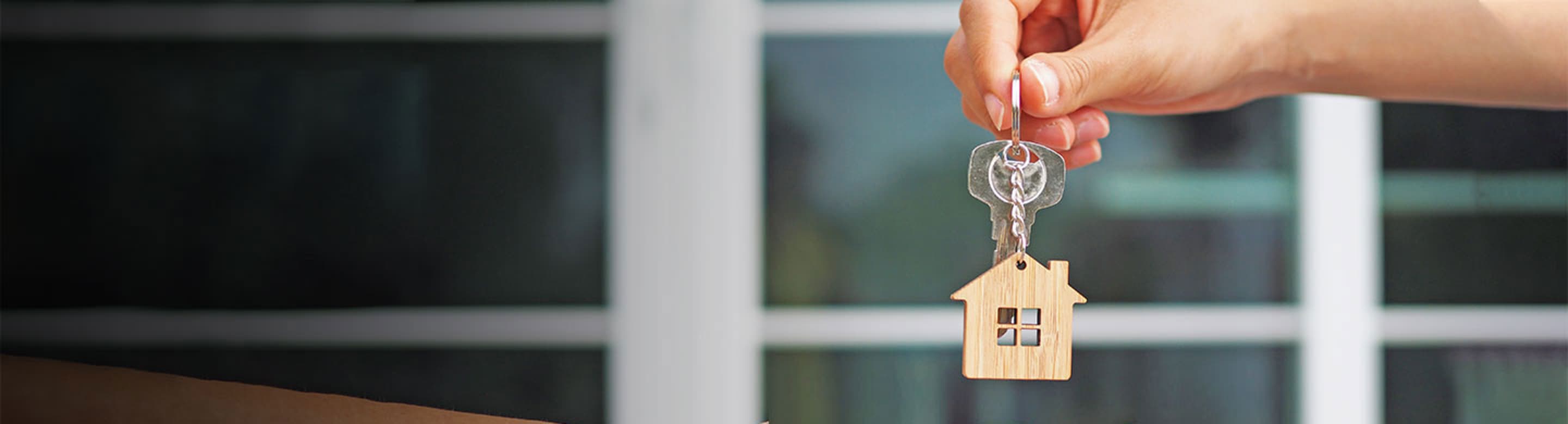 a landlord hands over the keys to a renter
