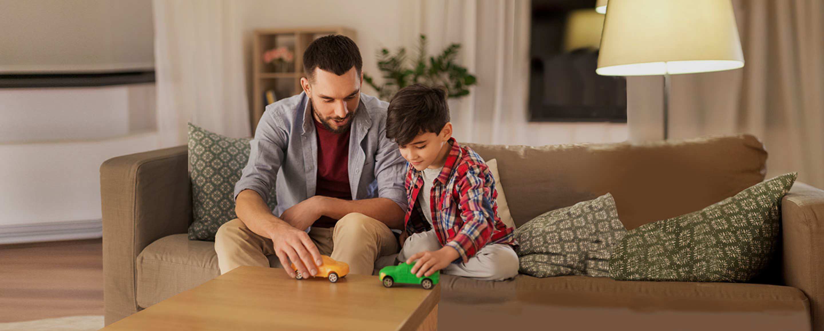 Dad and son playing with toy cars