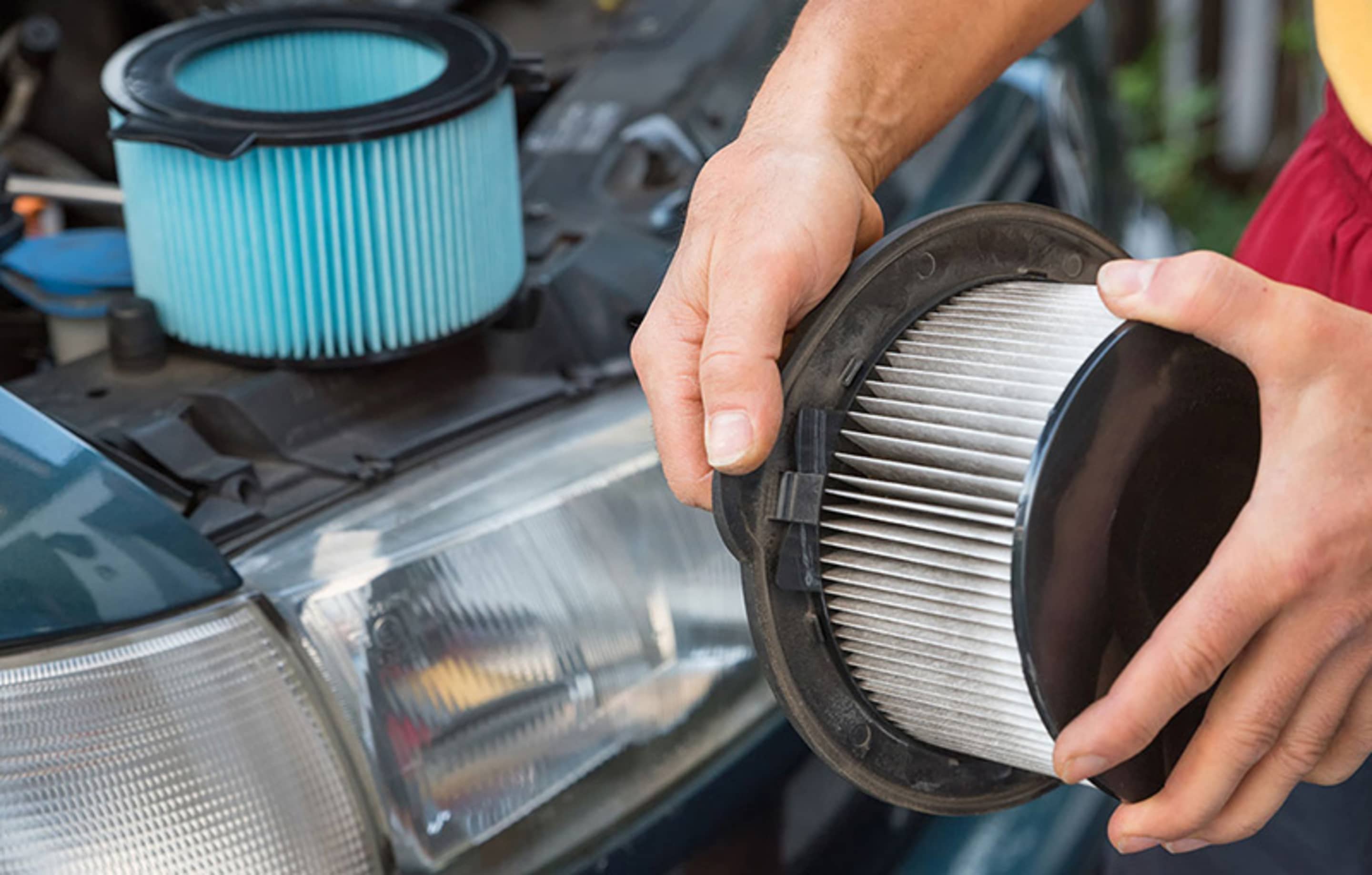 An auto repair technician inspects a AAA Member's car inside a AAA Auto Repair Center