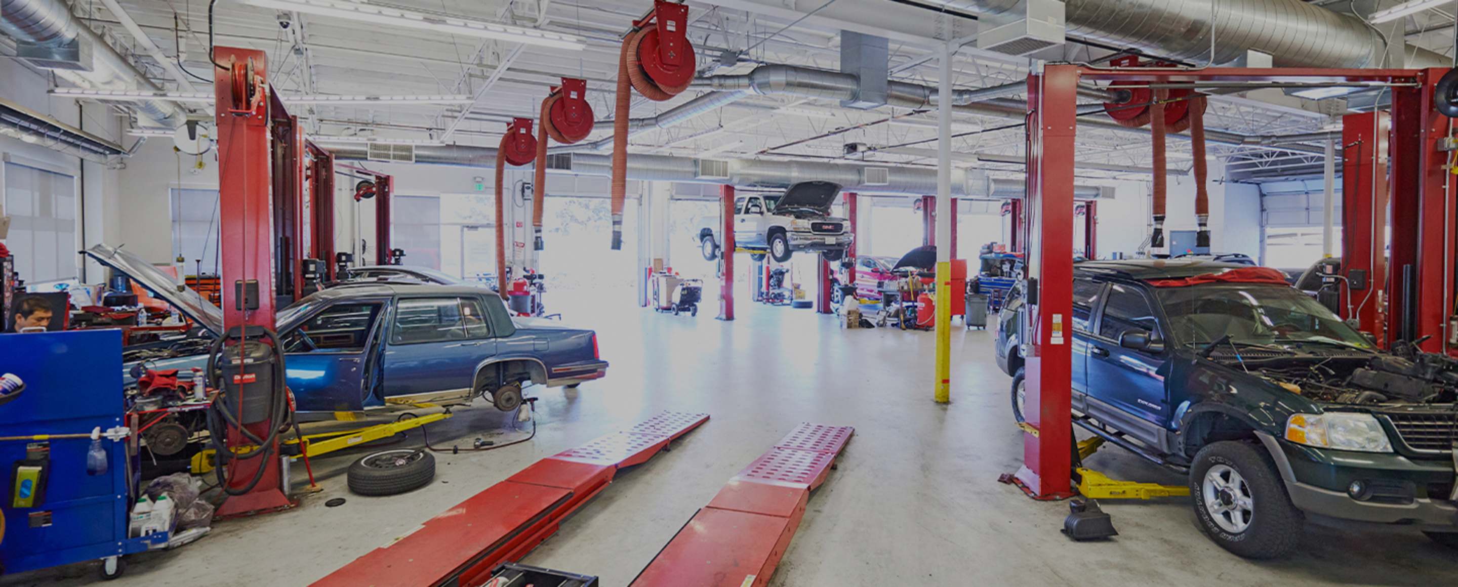 a red car getting maintenance in a AAA auto repair shop