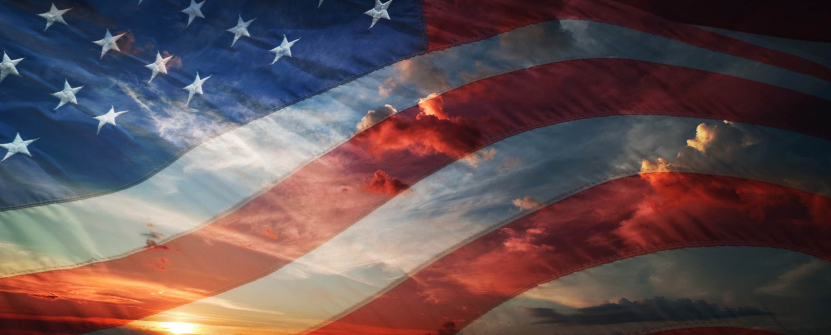sunset behind american flag