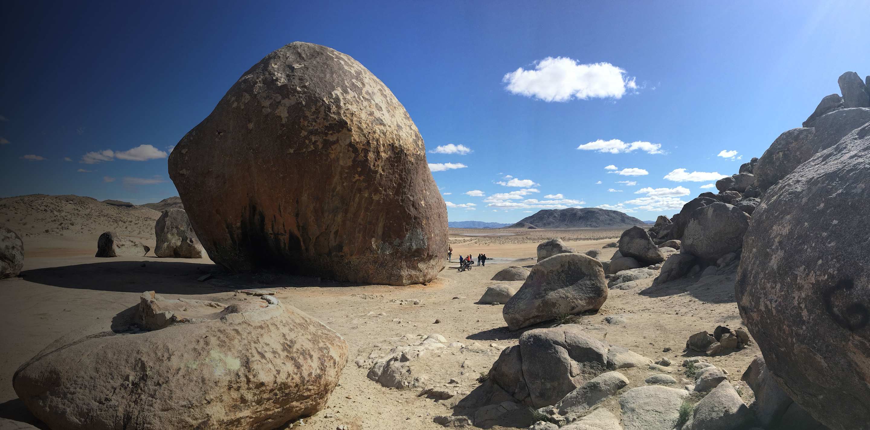Giant Rock in front of a cloudy blue desert sky in Landers, CA