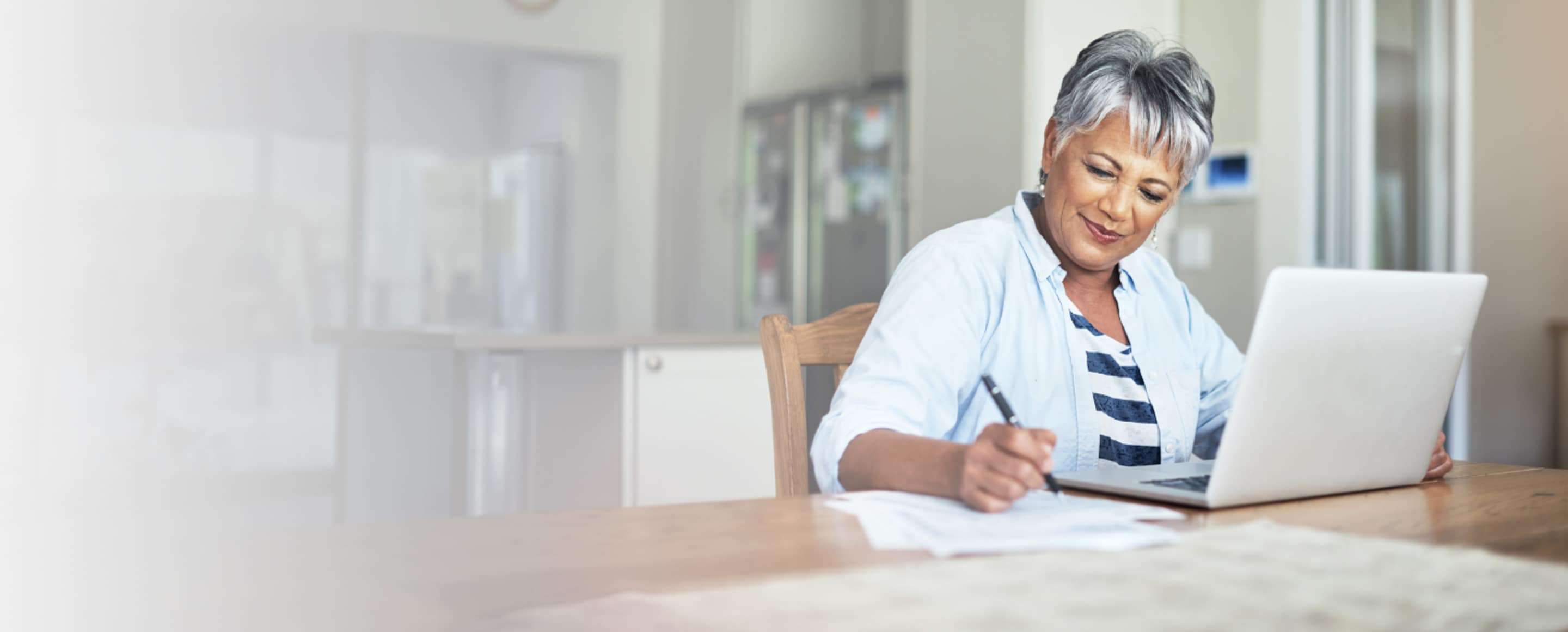 AAA Member sits at their computer taking notes about identity protection