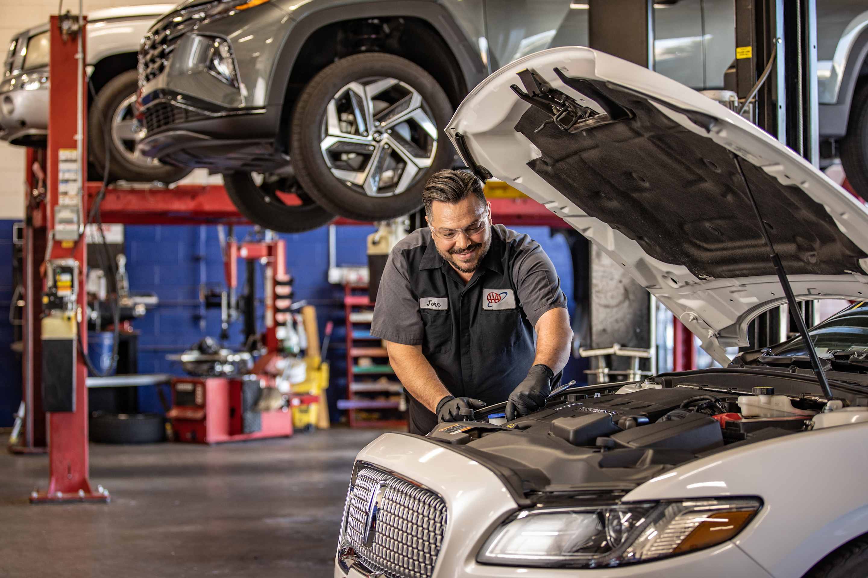 a AAA mechanic does a final car repair inspection