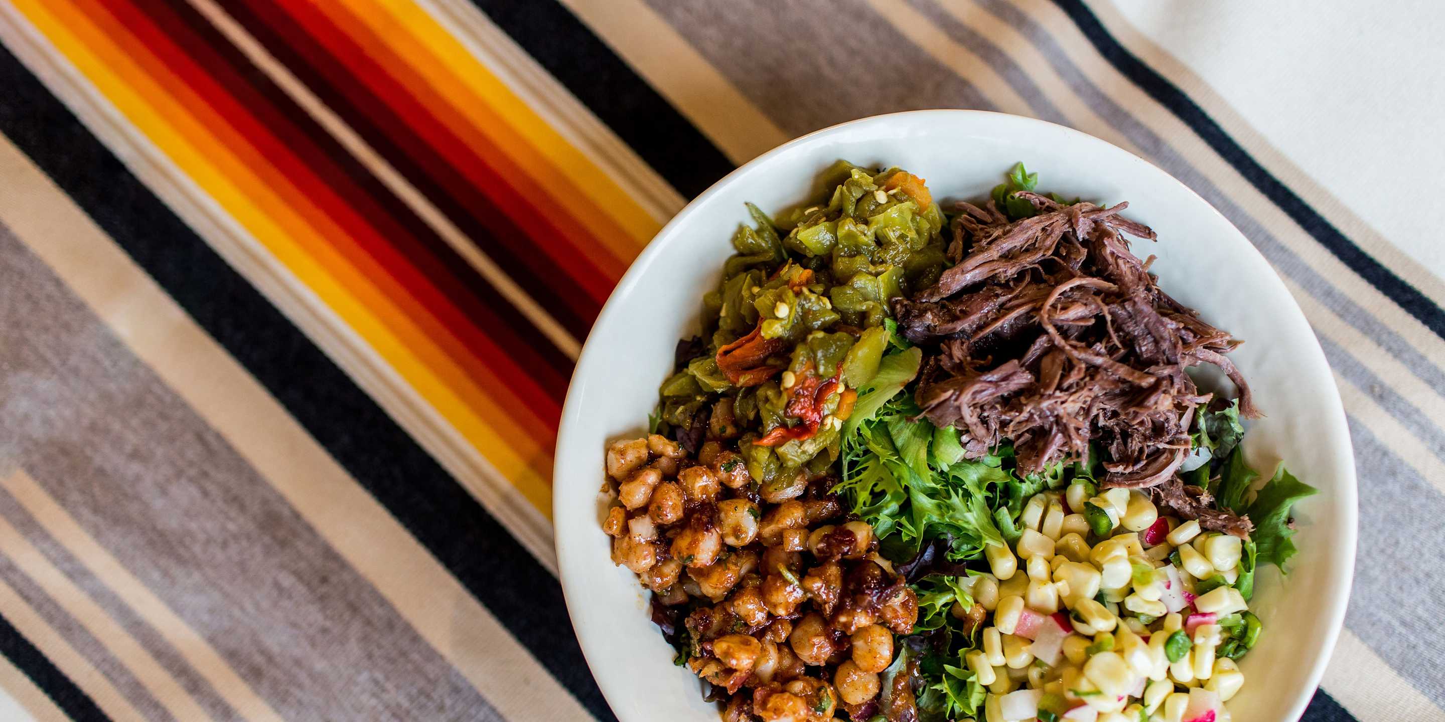 A dish on a bright tablecloth from Tacobe in Denver, Colorado.