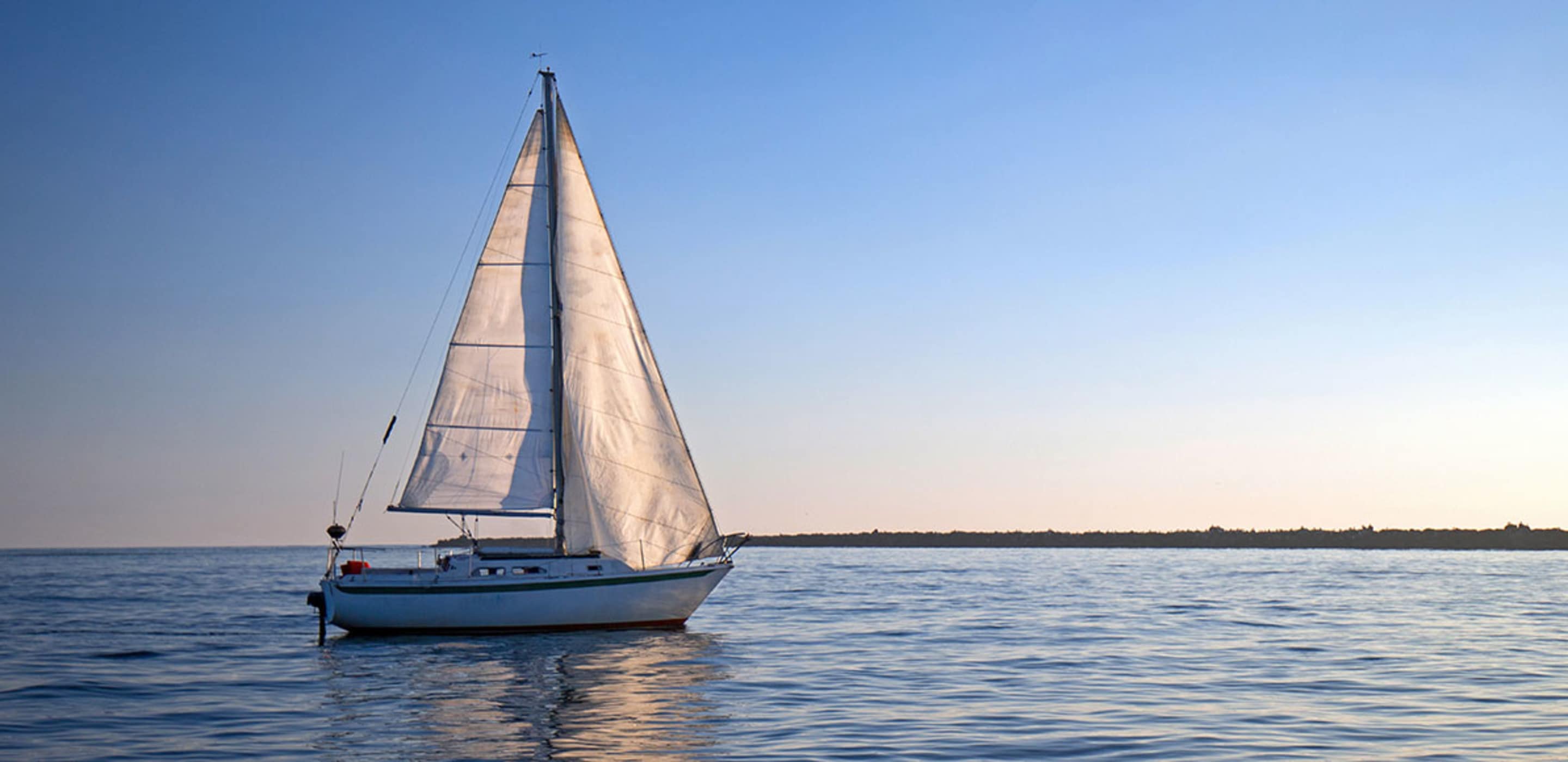 Sailboat protected by AAA insurance in the ocean.