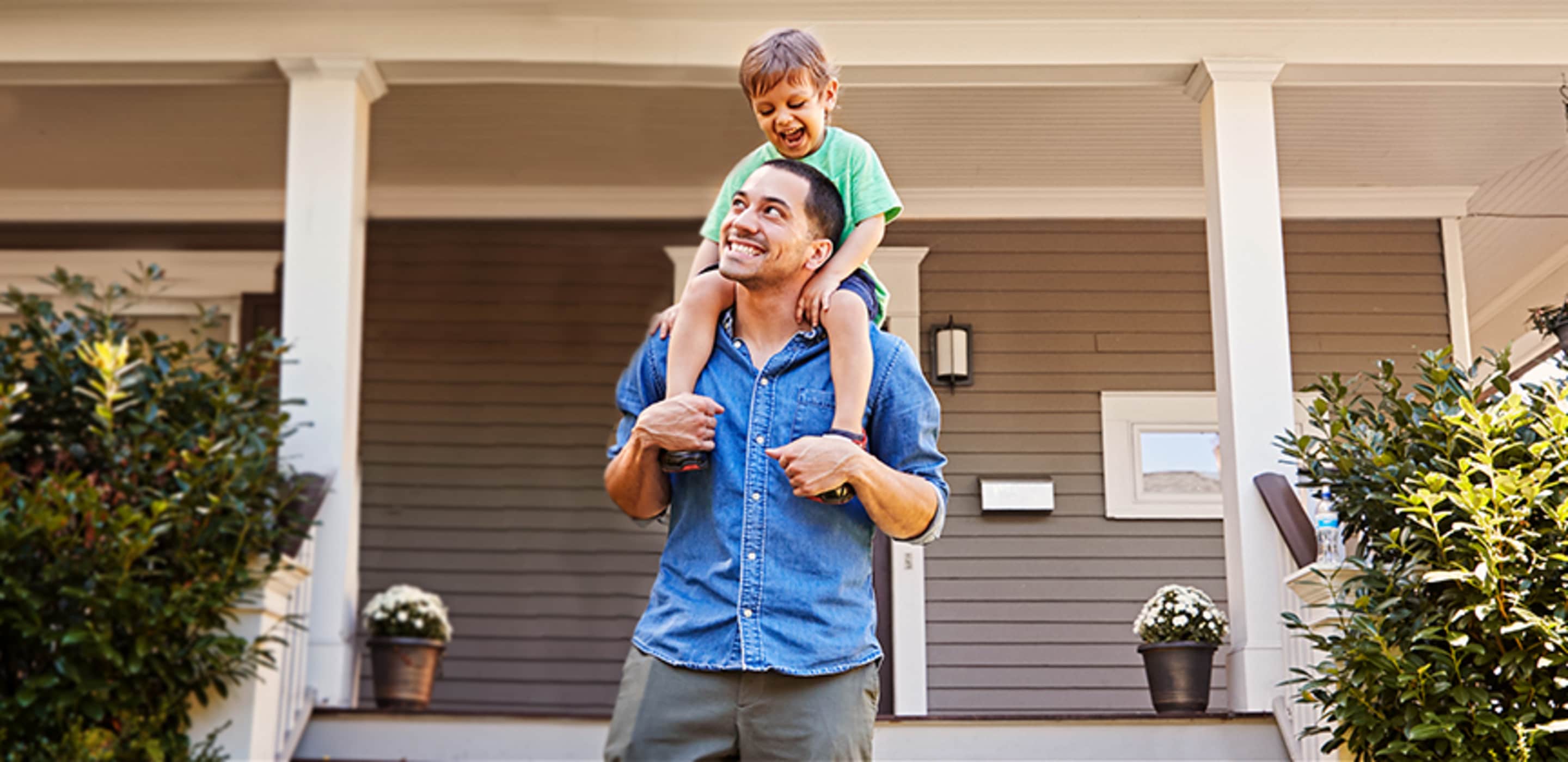 a dad pushes his daughter on a swing in front of their home covered with aaa earthquake insurance