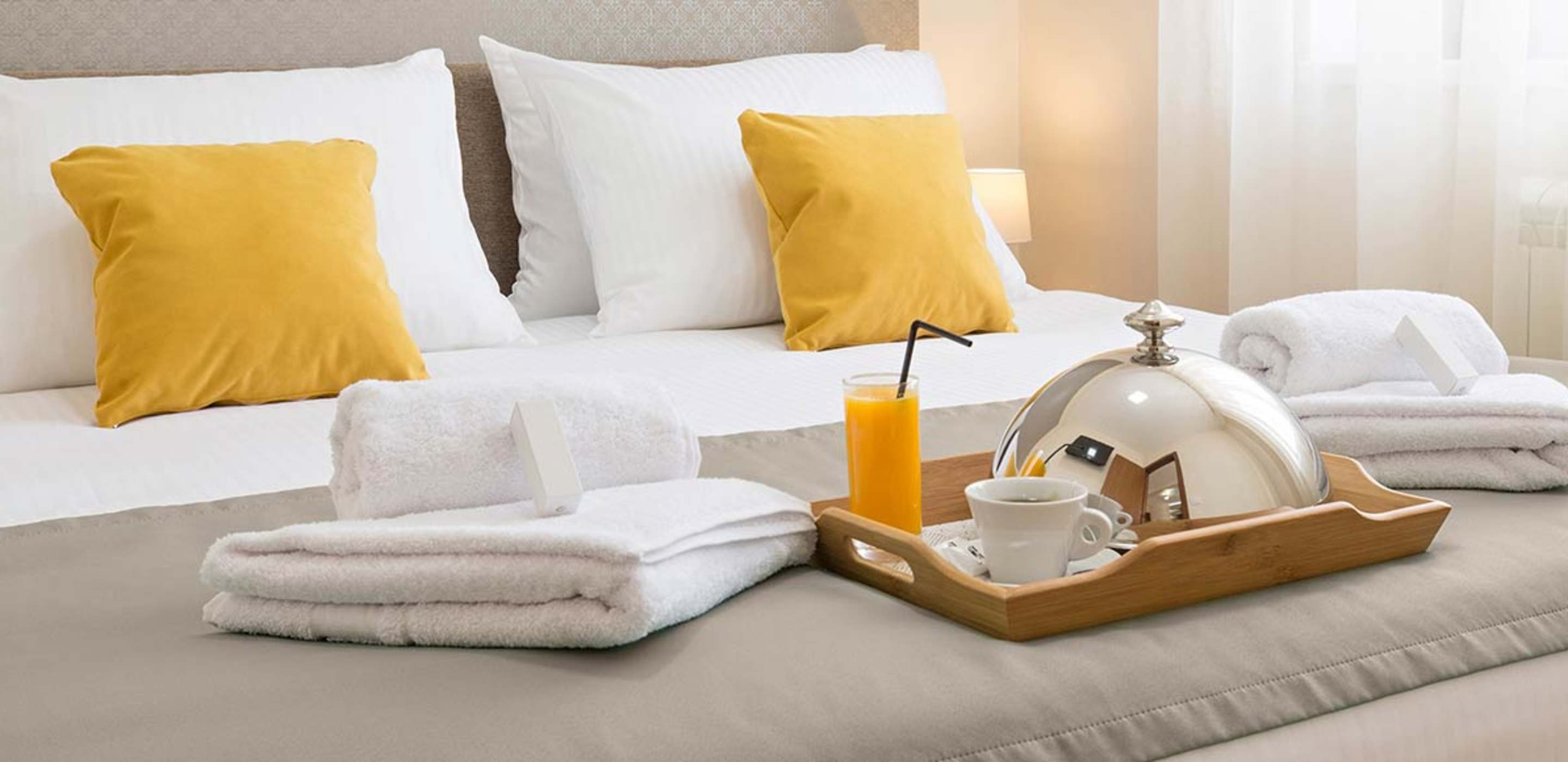 Luxurious bed in a hotel room booked through AAA