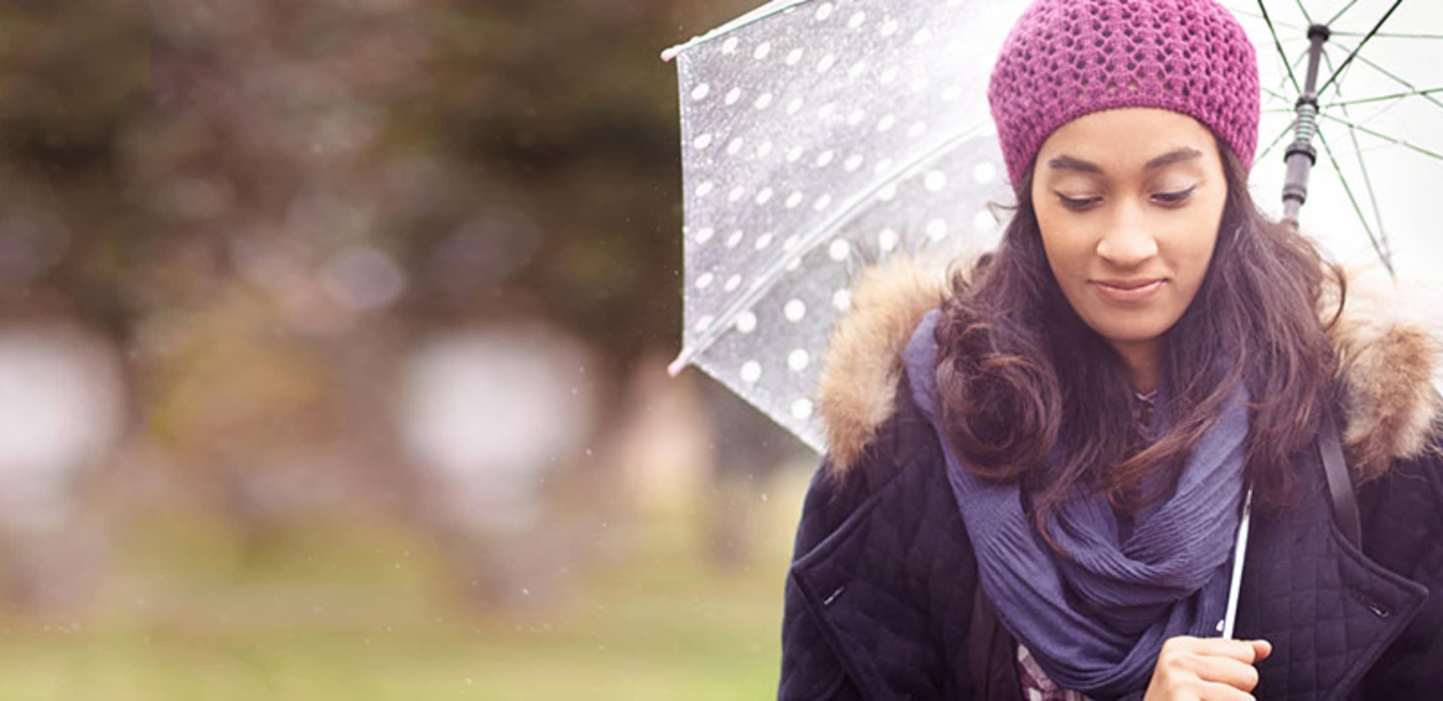 a person carries an umbrella in the rain